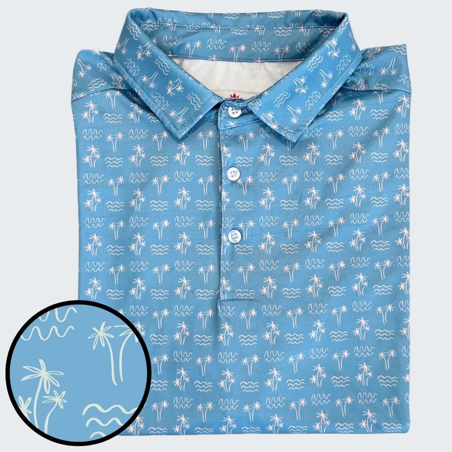 Blue shirt with white palm tree and wave pattern on a white background