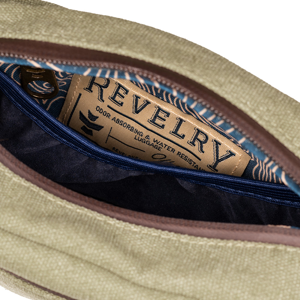 Close-up of a beige pouch with a 'Revelery' label inside, on a white background.