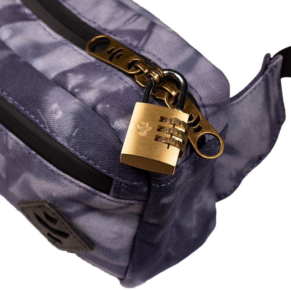 Gold padlock on a gray bag with a white background
