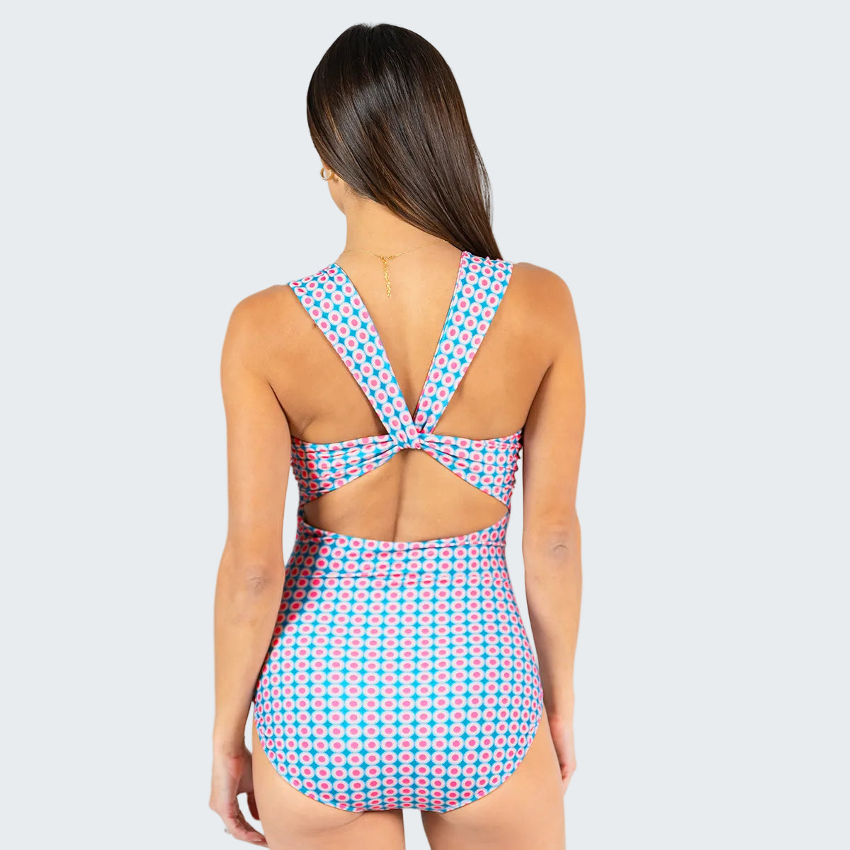Woman wearing a polka dot swimsuit with a white background
