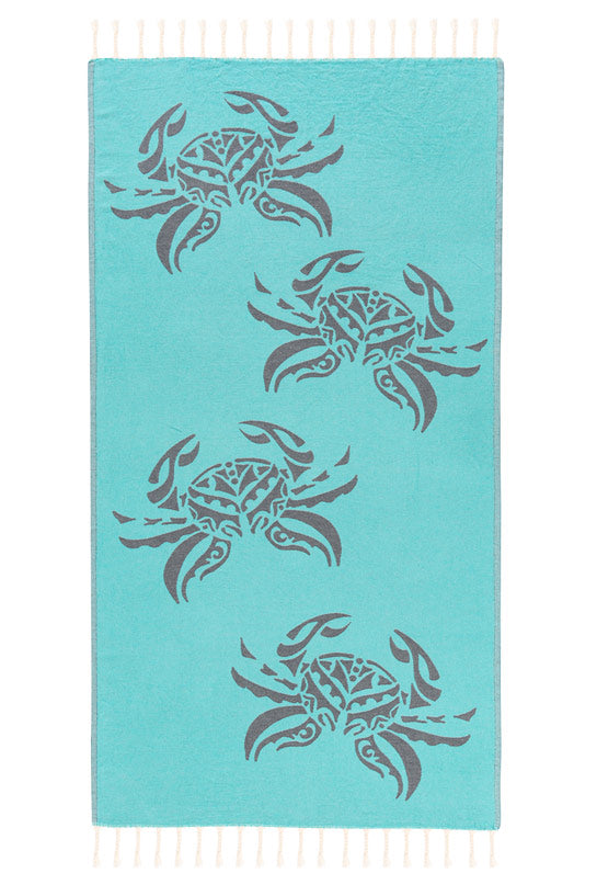 Turquoise towel with crab patterns on a white background