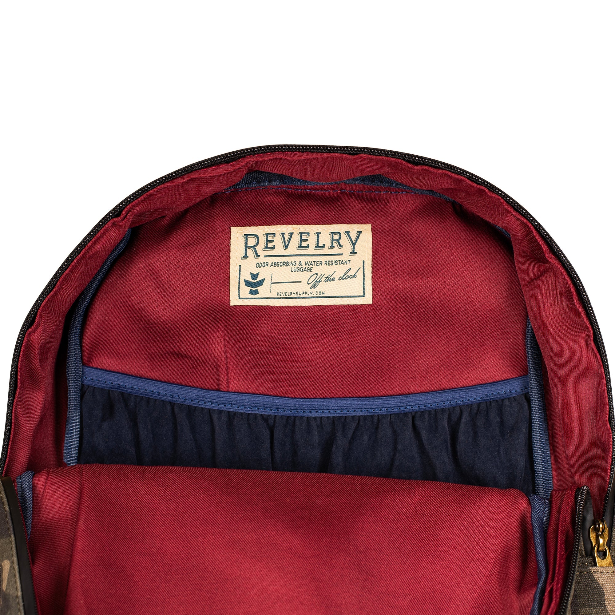 Red backpack with a visible 'Revelry' label on a white background