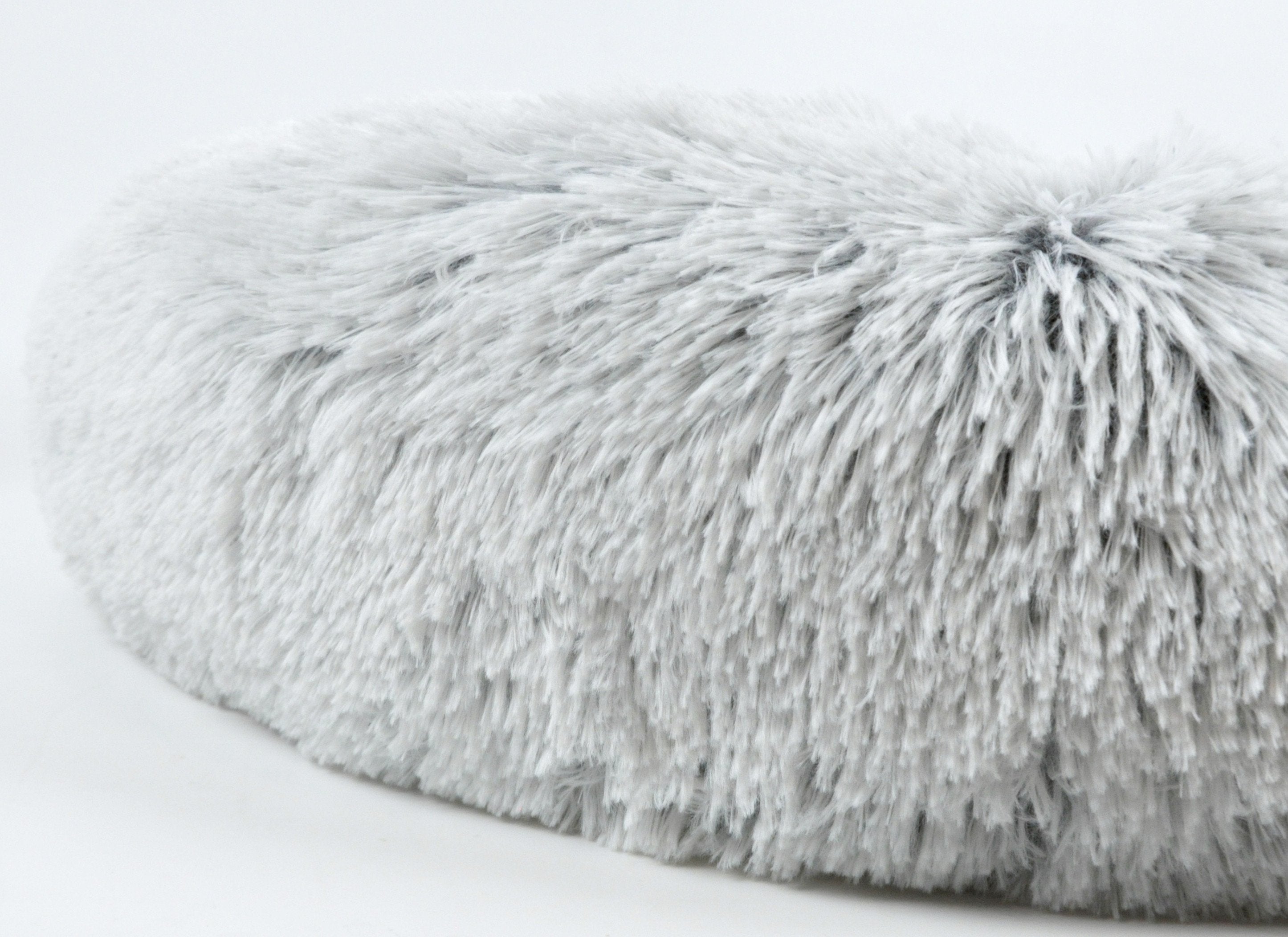 Close-up of a fluffy gray rug on a white background