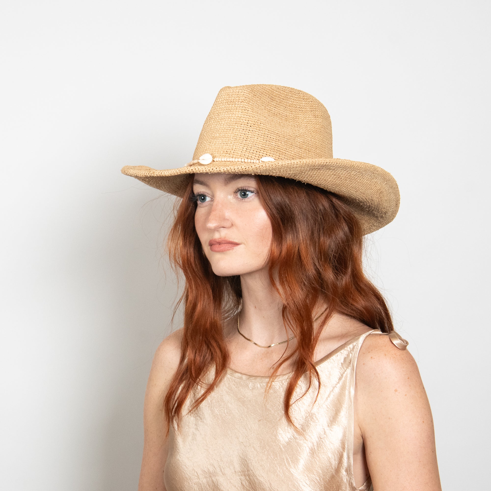 Woman wearing a straw hat with a white background
