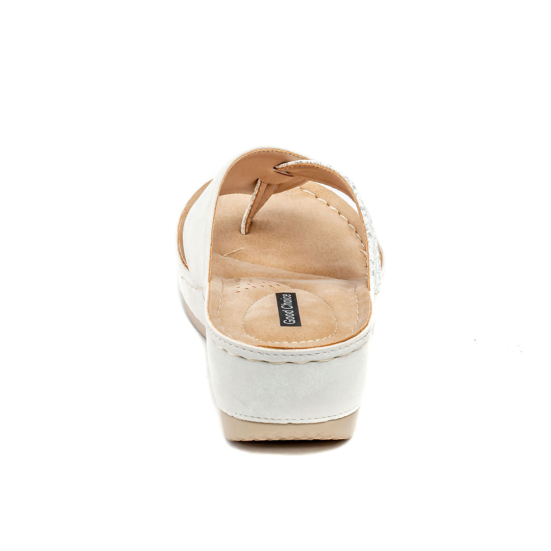 White sandal with tan sole on a white background