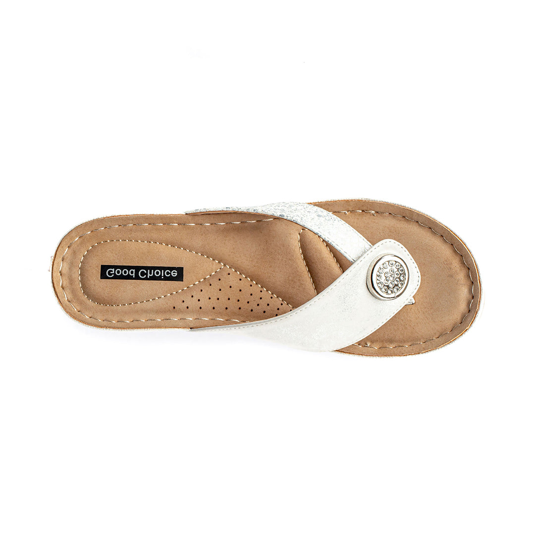 Tan sandal with white strap and decorative button on a white background