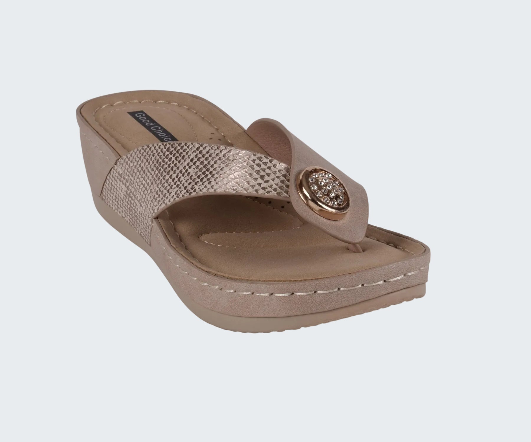 Beige wedge sandal with a decorative strap on a white background