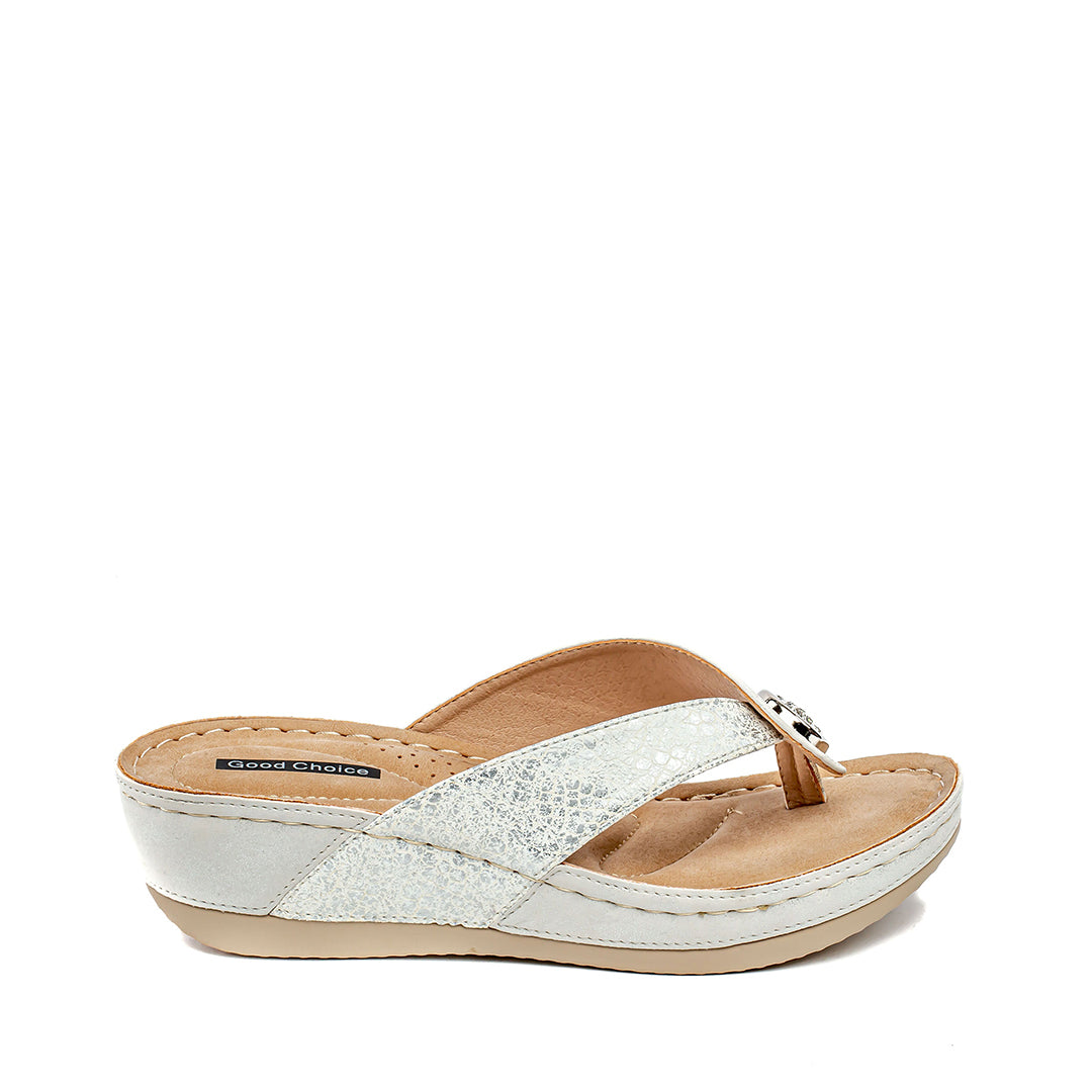White sandal with a tan sole on a white background