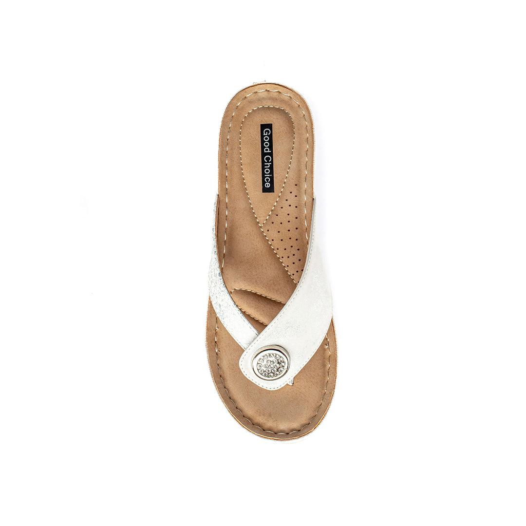 White sandal with tan sole on a white background