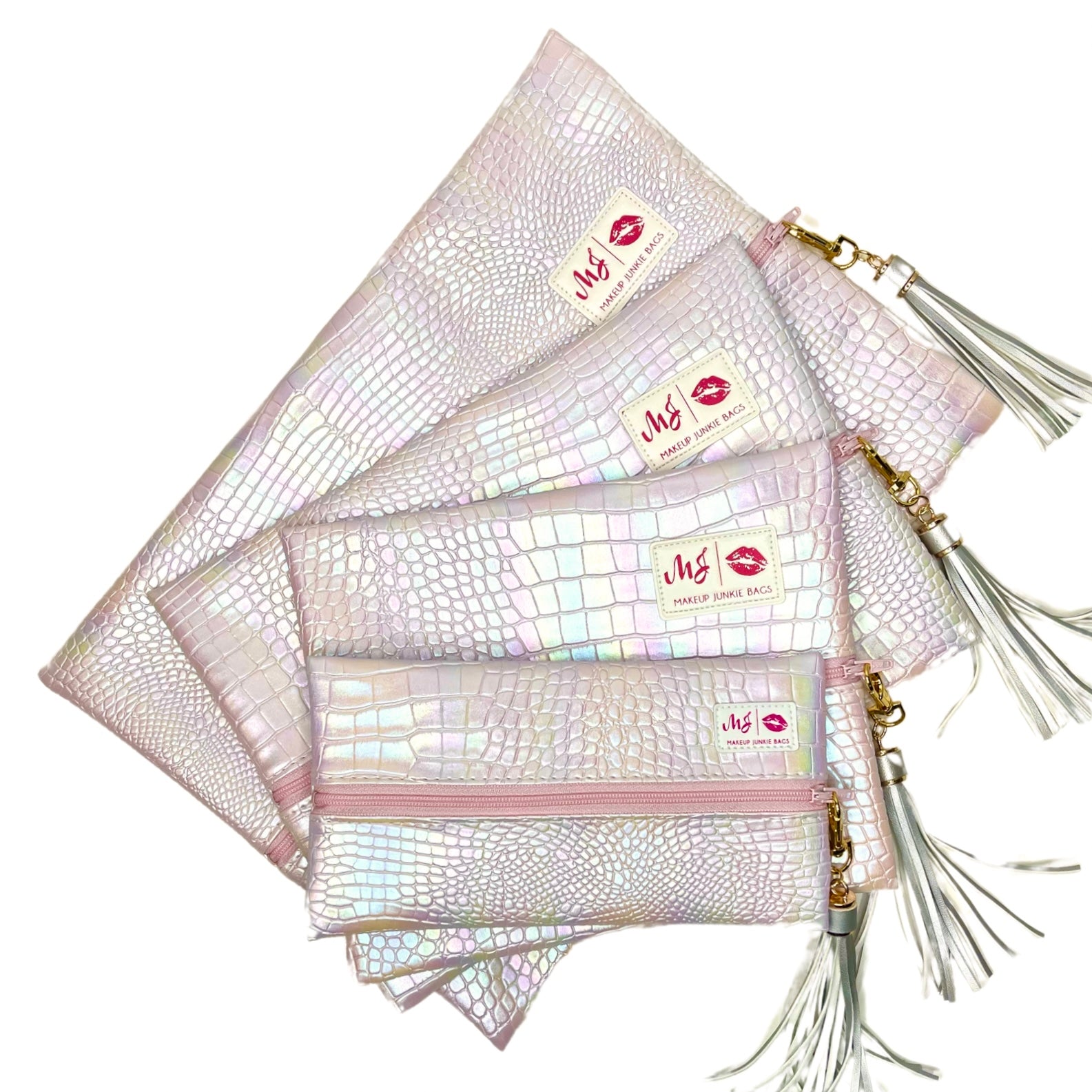 Set of iridescent makeup bags with gold zippers and tassels on a white background