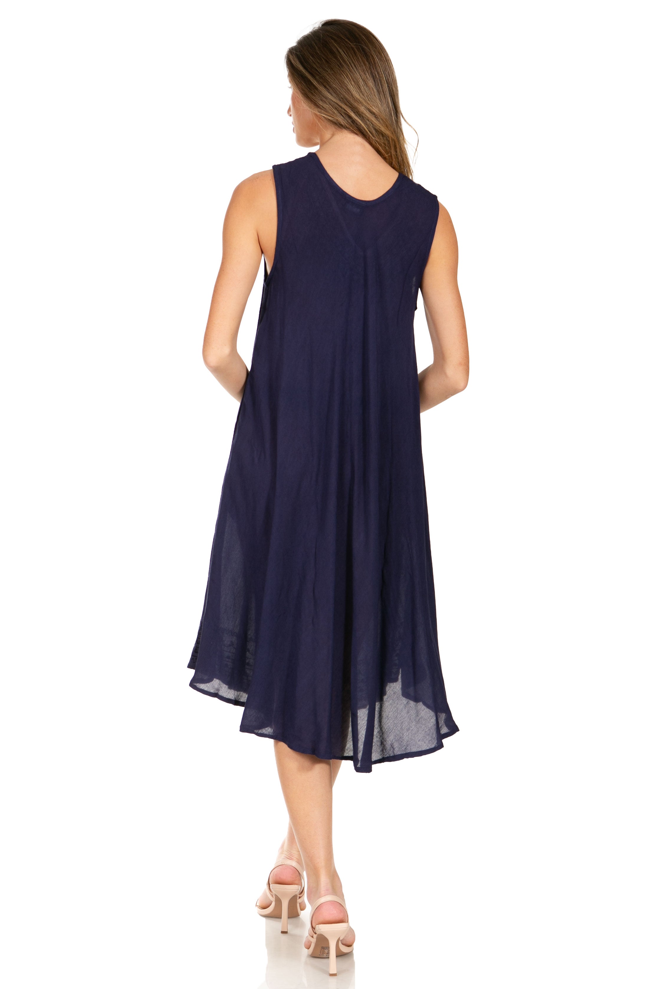 Woman wearing a navy blue sleeveless dress on a white background