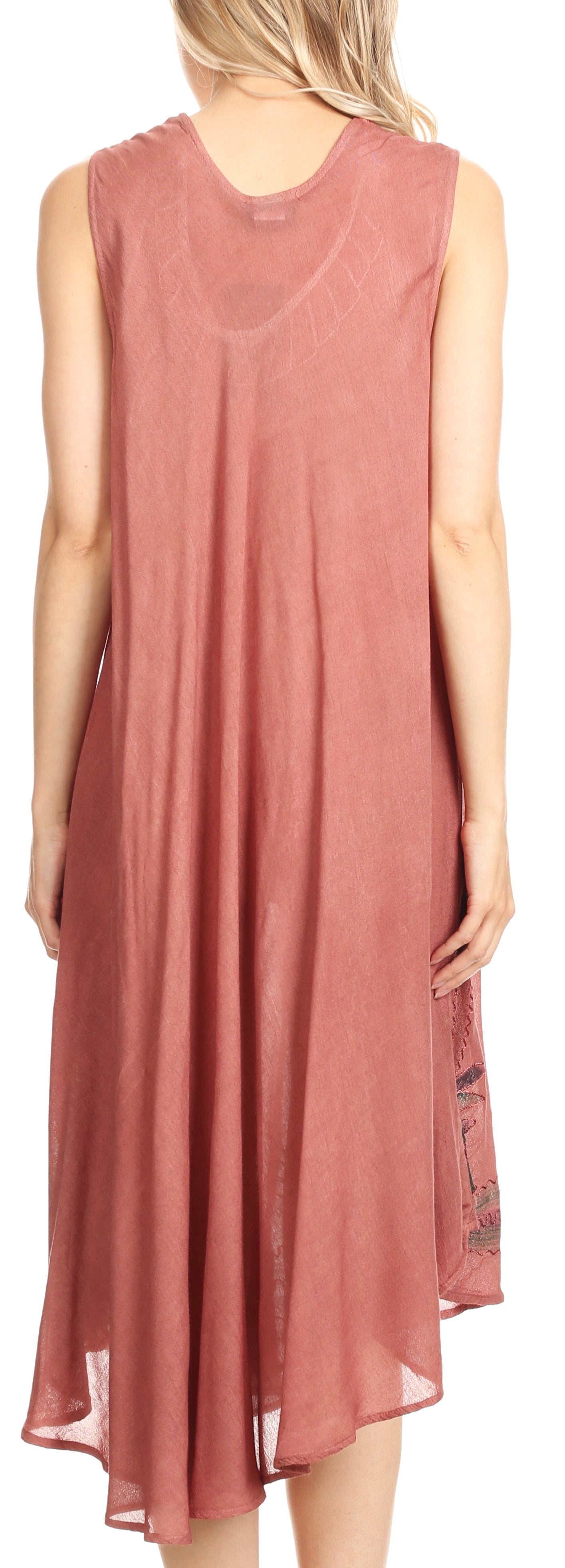 Woman wearing a sleeveless, long pink dress with lace details on the back.