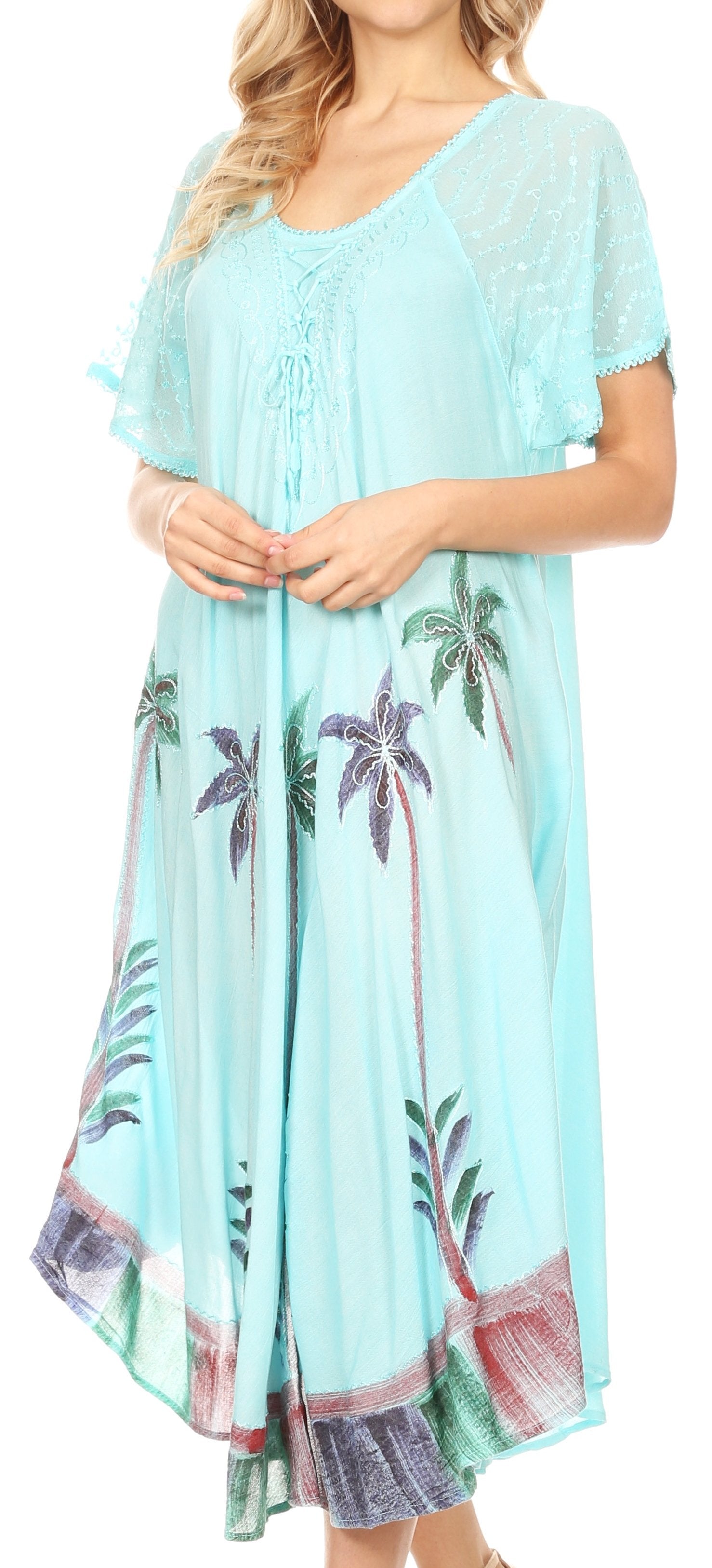 Light blue dress with palm tree print worn by a model