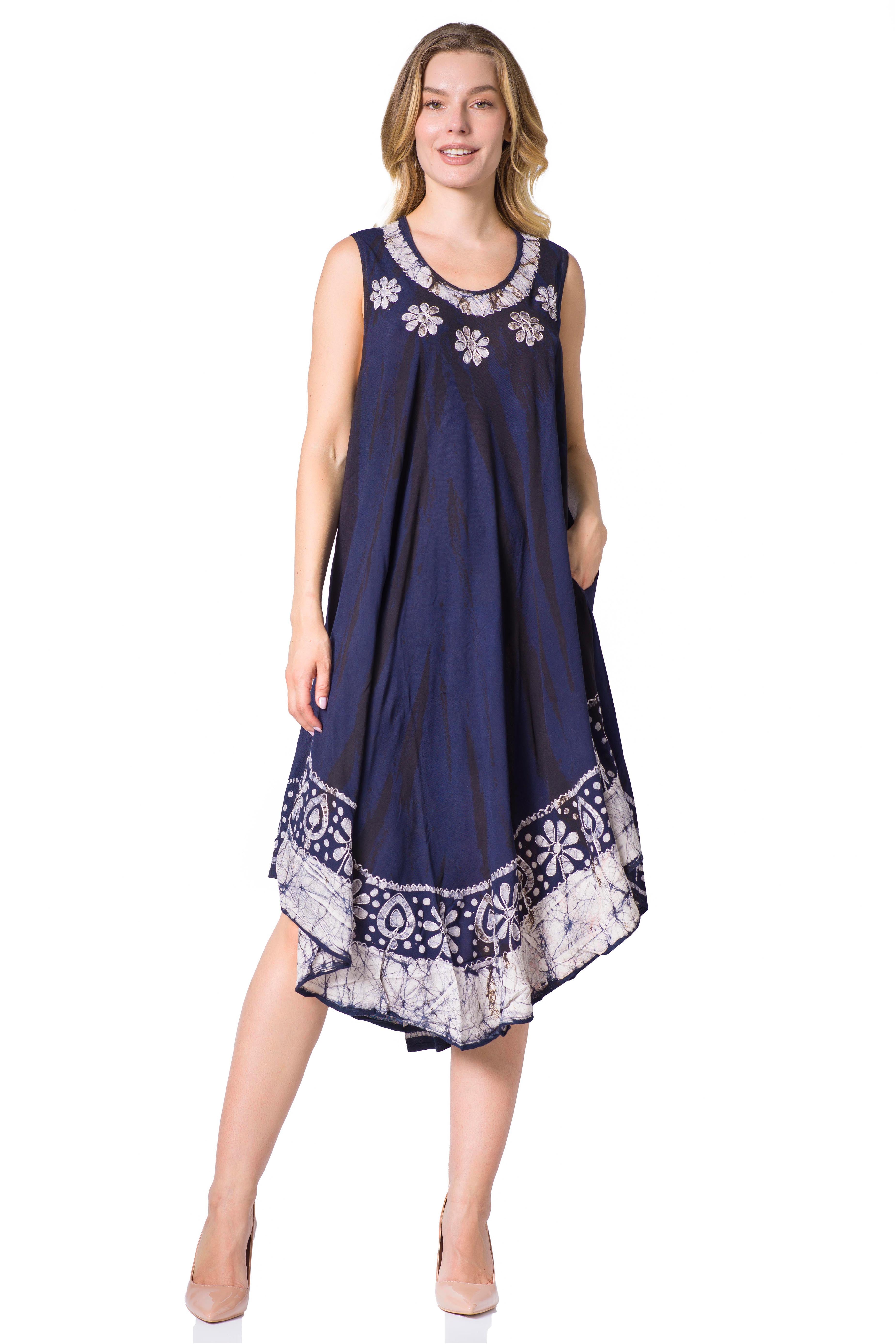 Woman wearing a navy blue dress with white floral embroidery on a white background