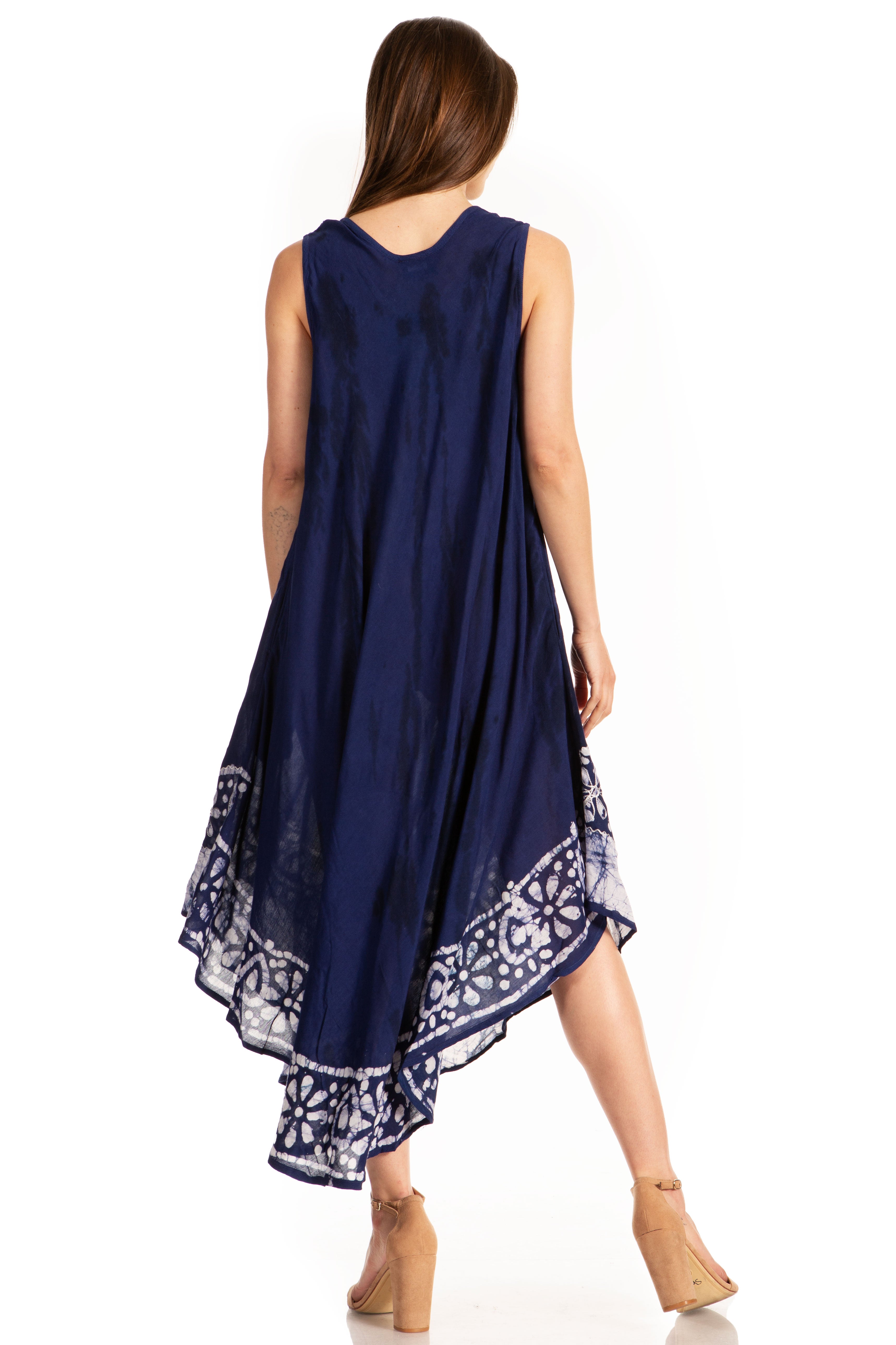 Woman wearing a navy blue sleeveless dress with white patterns on a white background