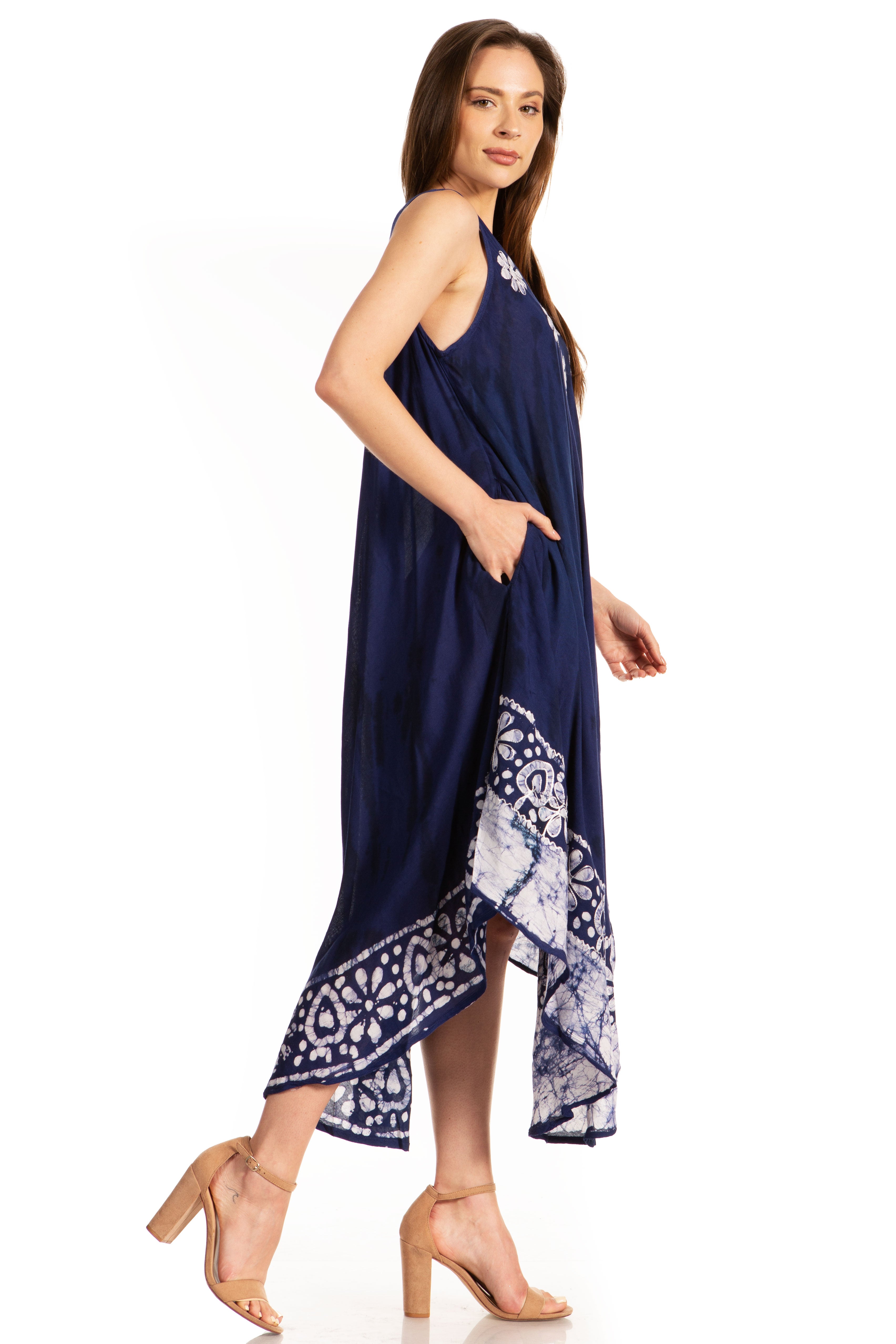Woman wearing a navy blue dress with a patterned hem on a white background