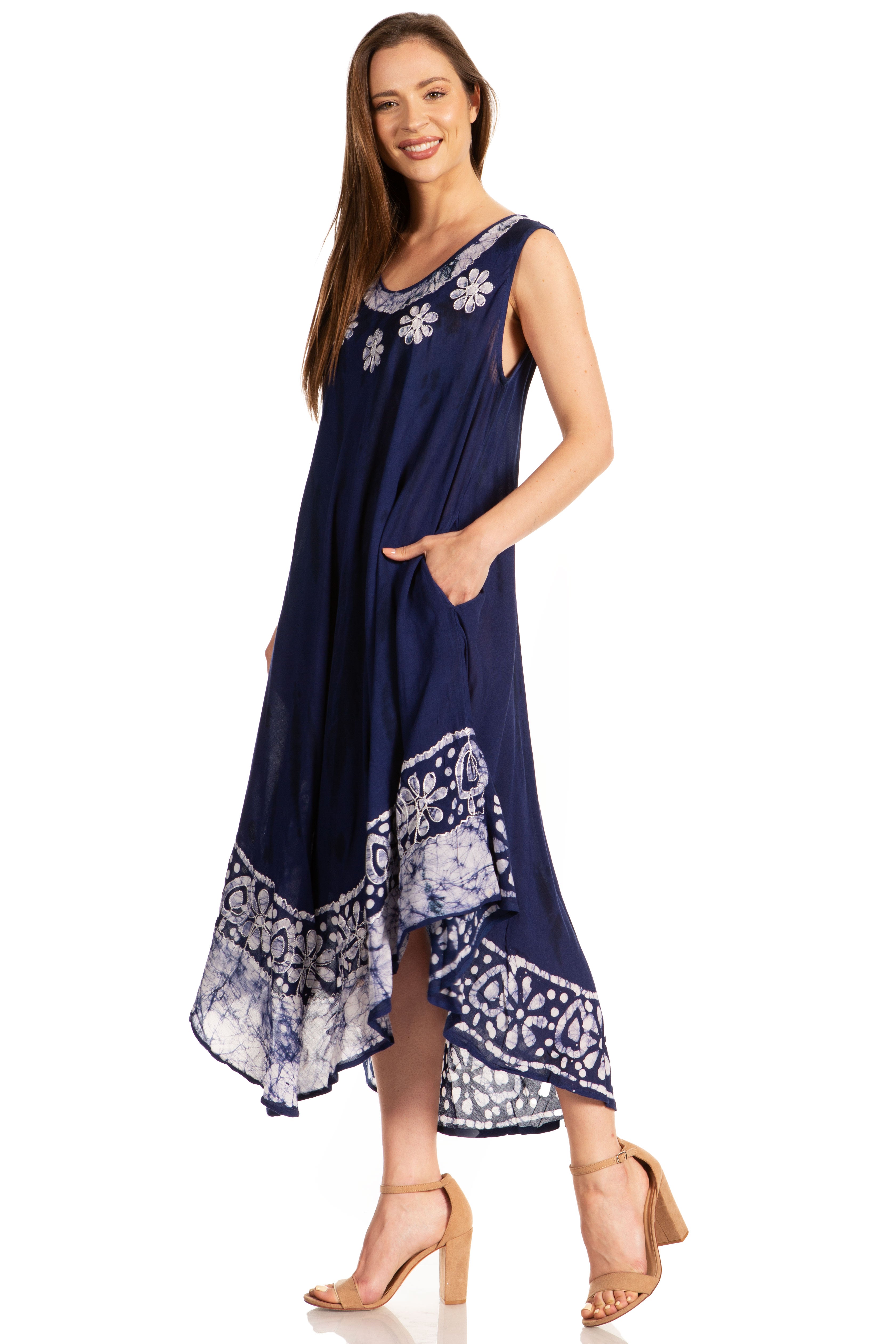 Woman wearing a navy blue dress with white floral patterns on a white background