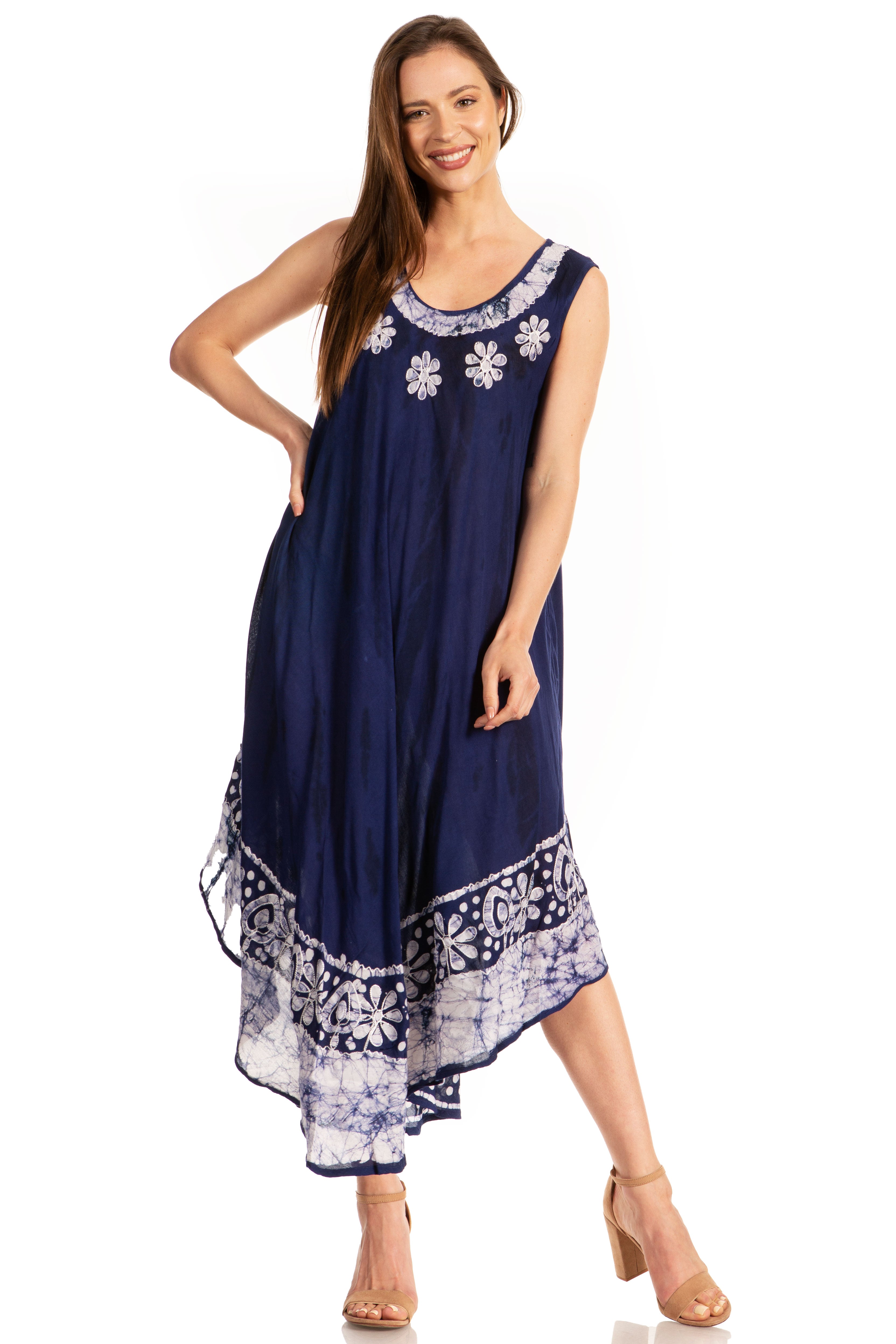 Woman wearing a navy blue dress with white floral embroidery on a white background