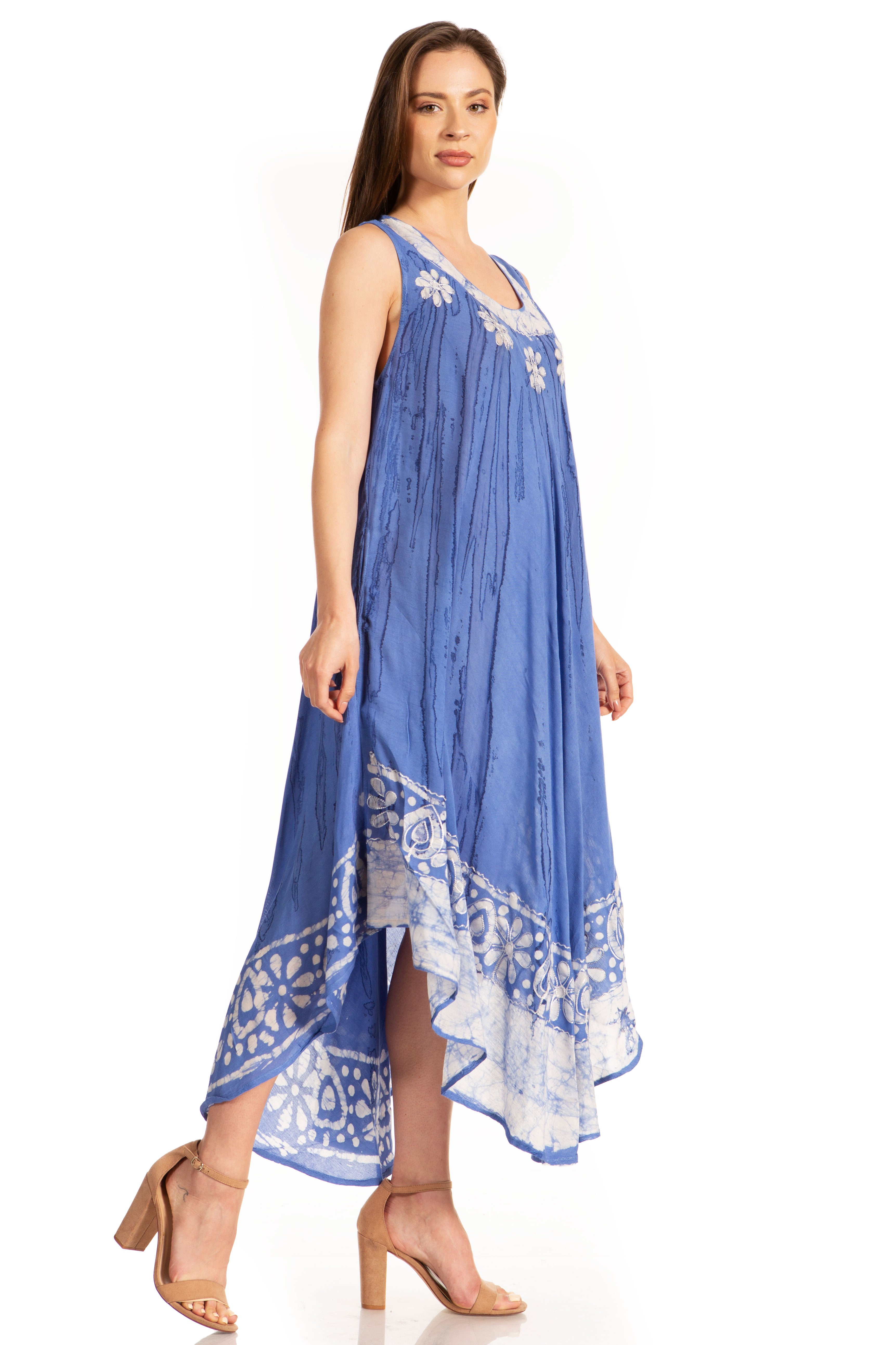 Woman wearing a blue dress with white patterns on a white background