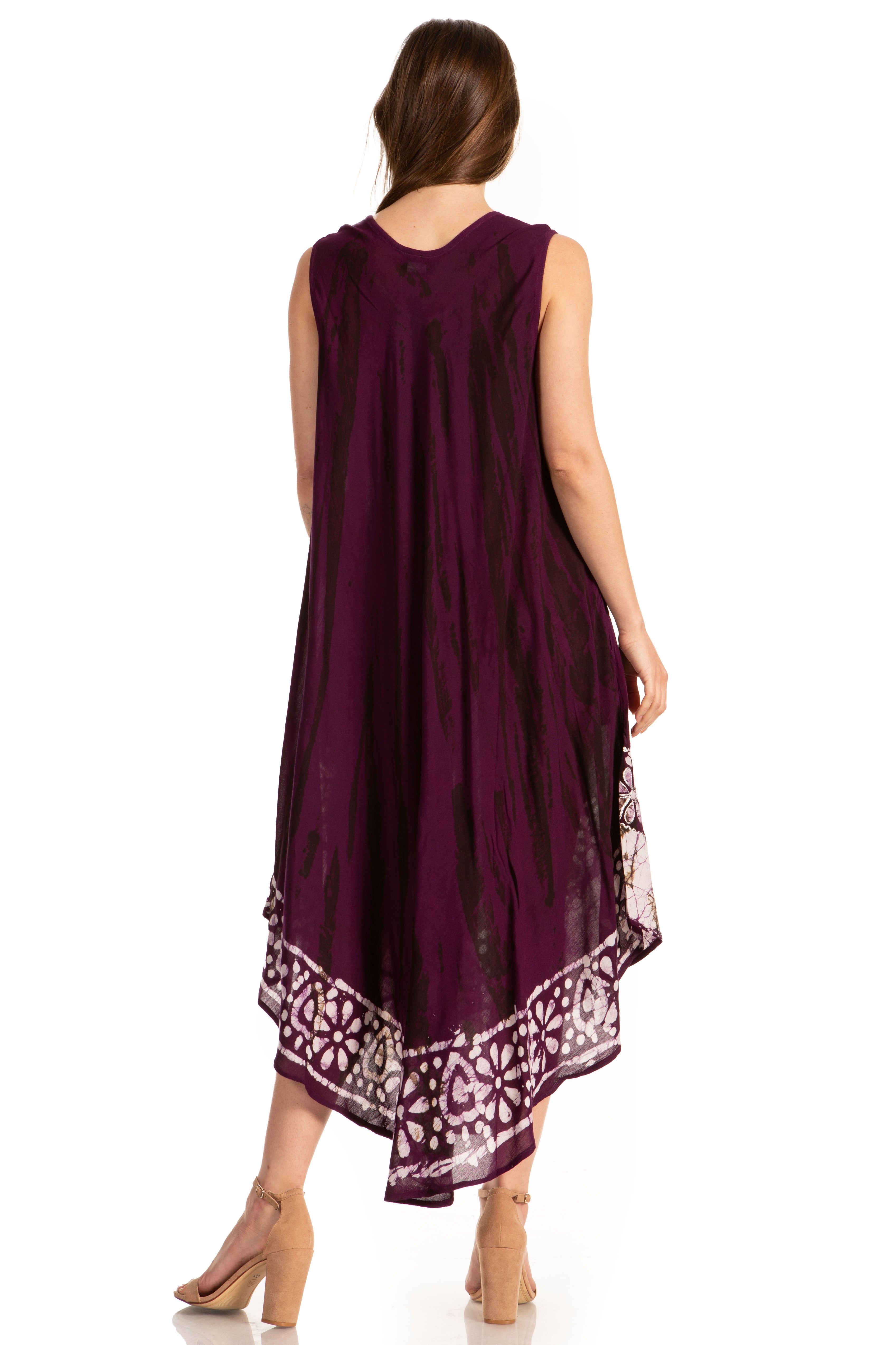 Woman wearing a long purple dress with a patterned hem on a white background