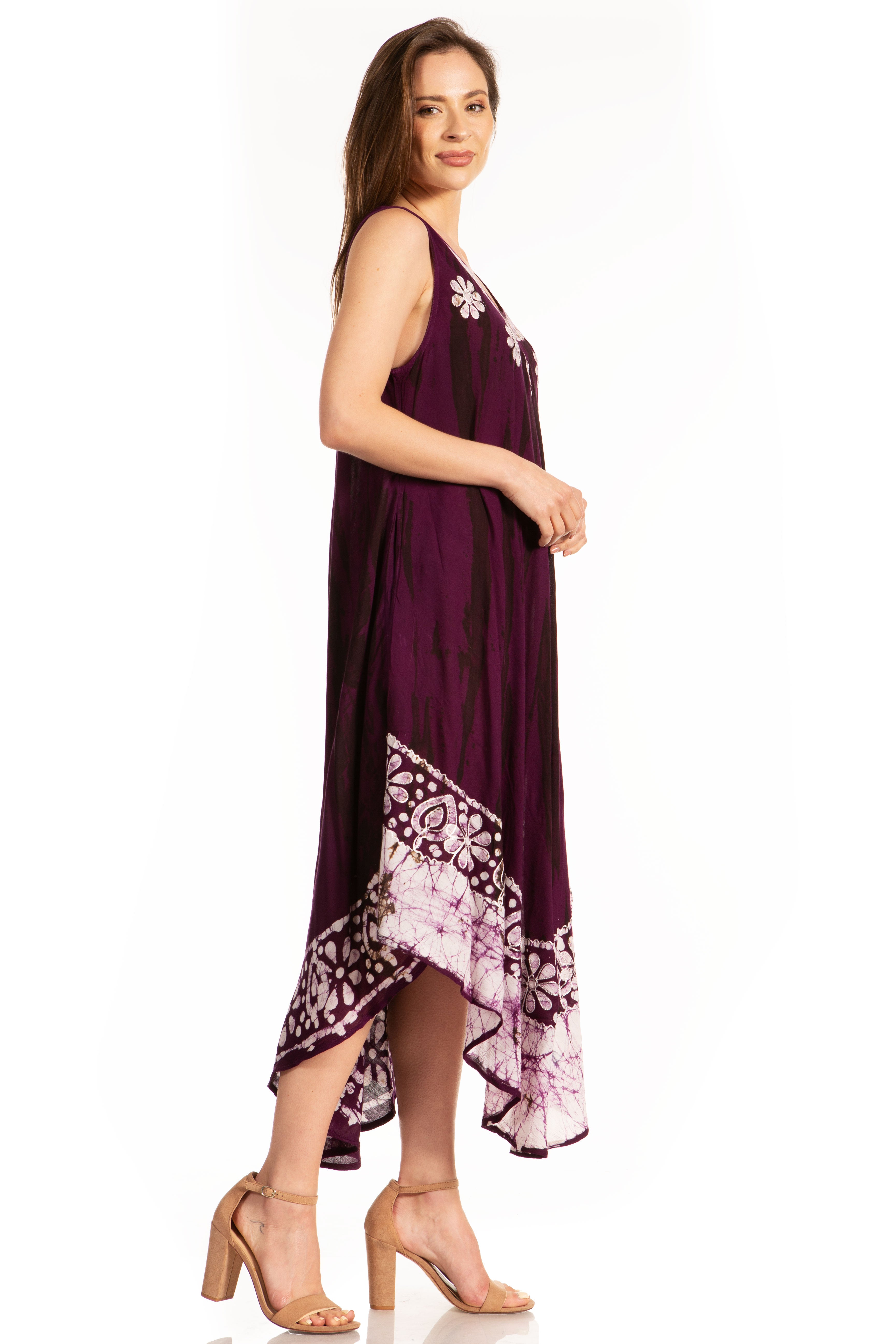 Woman wearing a purple dress with floral patterns on a white background