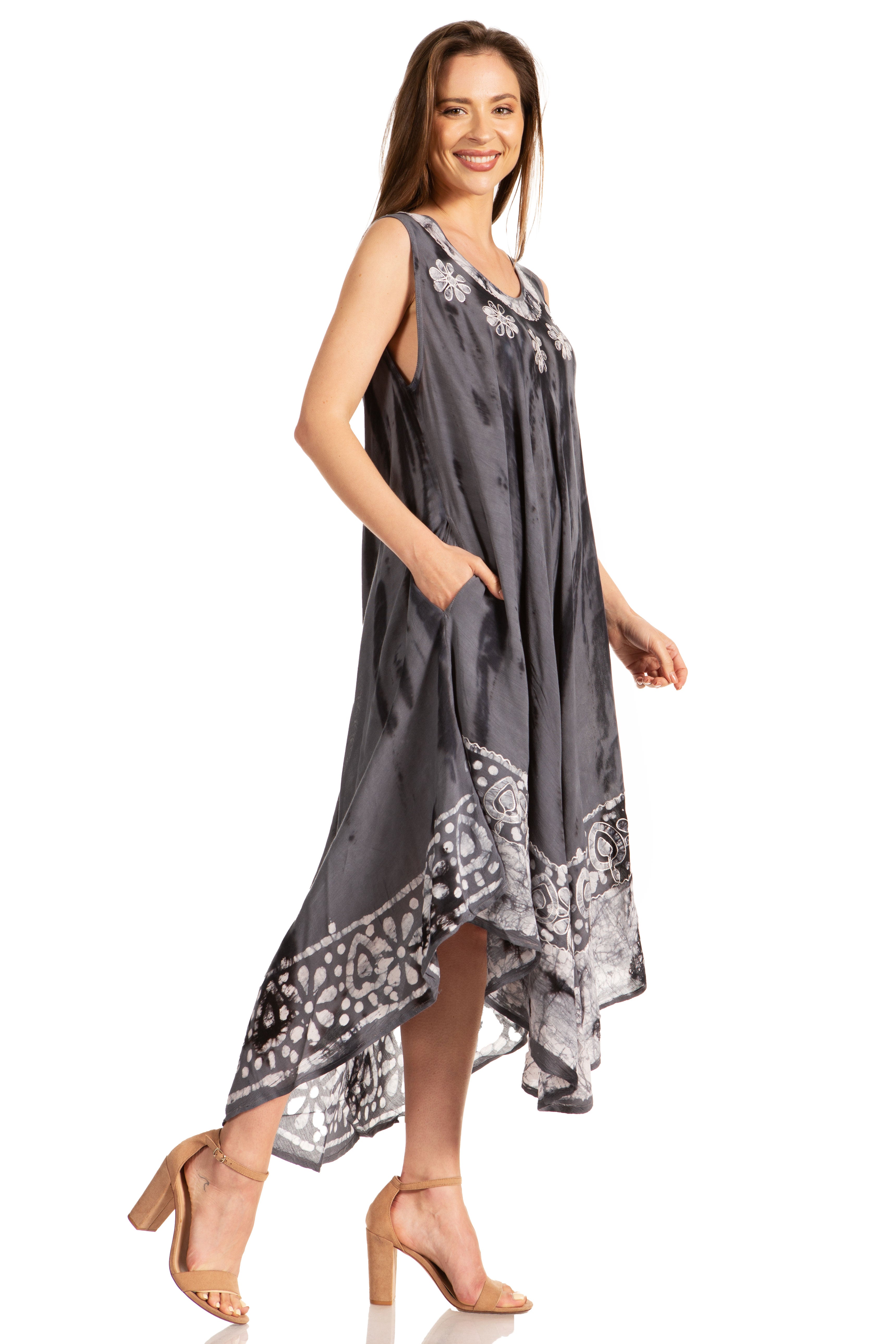 Woman wearing a gray sleeveless dress with floral patterns on a white background