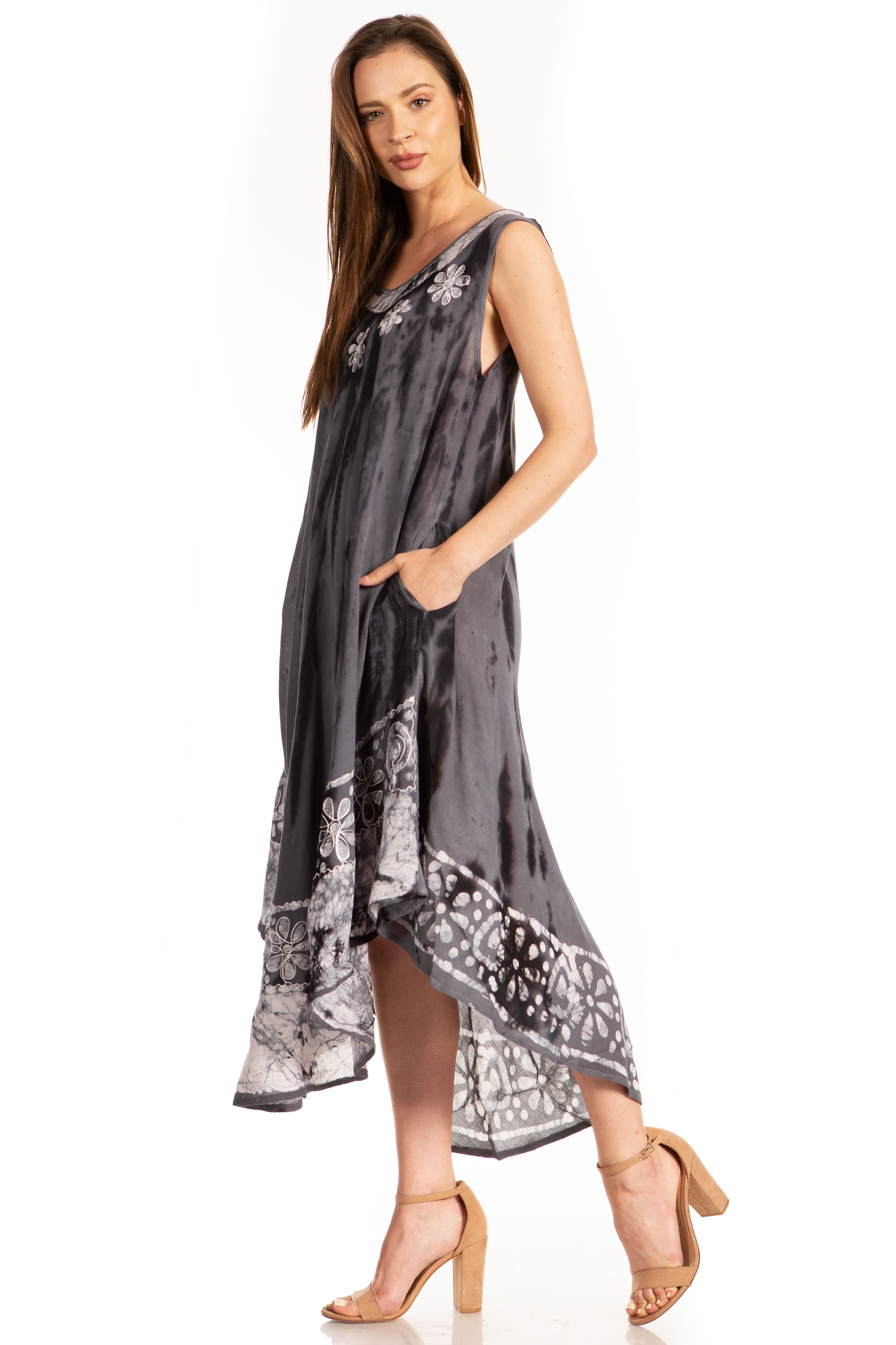Woman wearing a gray sleeveless dress with floral patterns on a white background