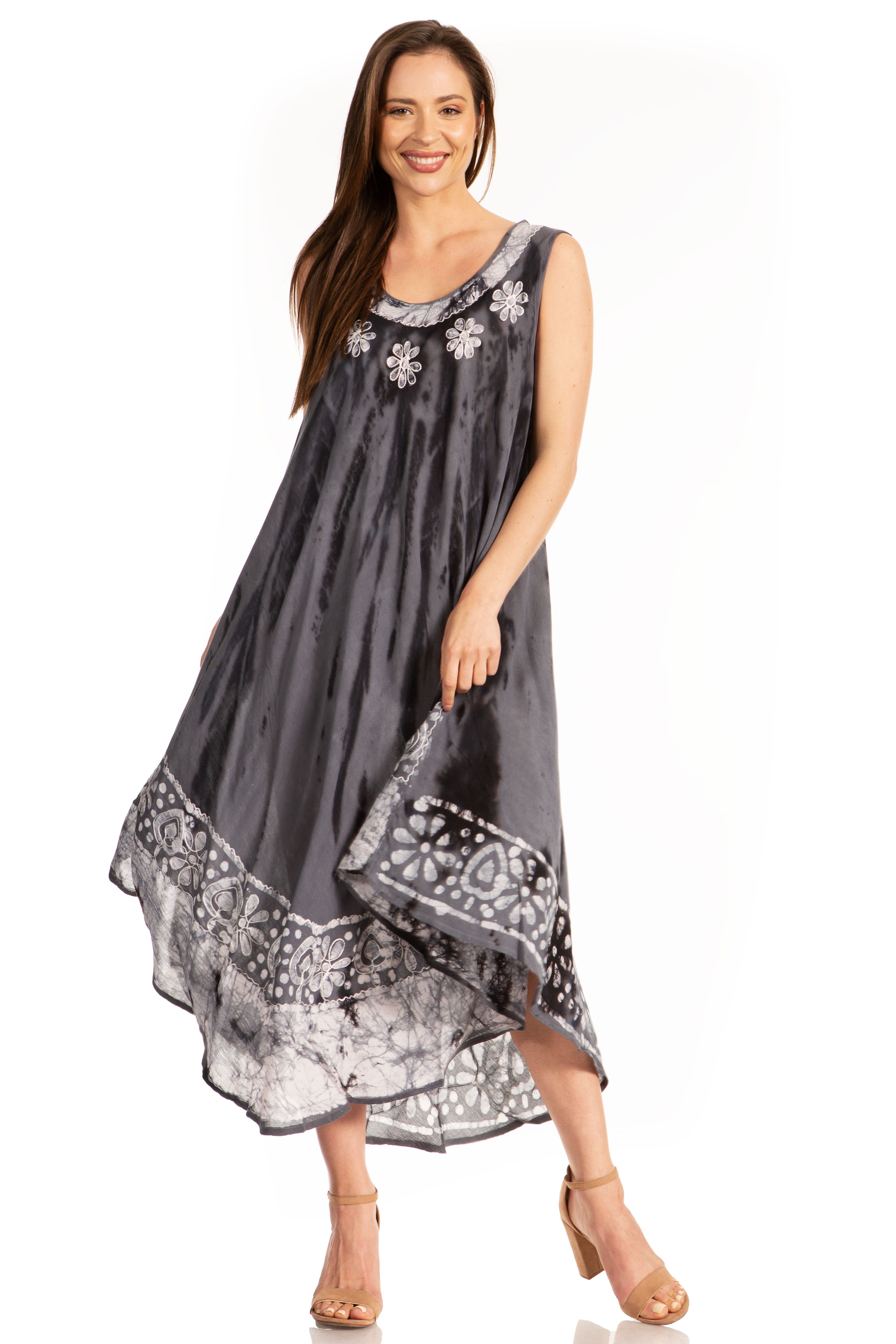 Woman wearing a gray dress with floral patterns on a white background