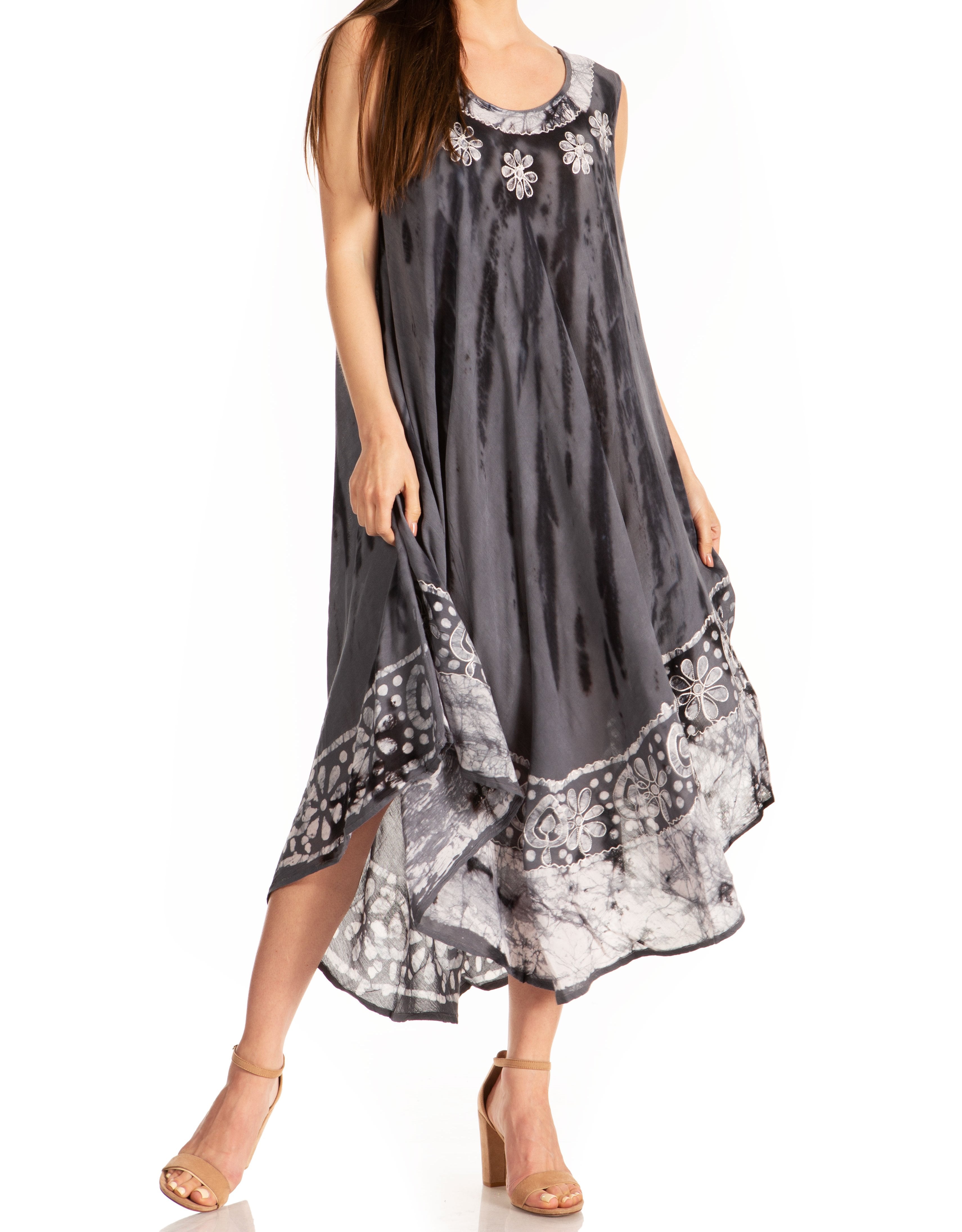 Woman wearing a gray sleeveless dress with floral patterns on a white background