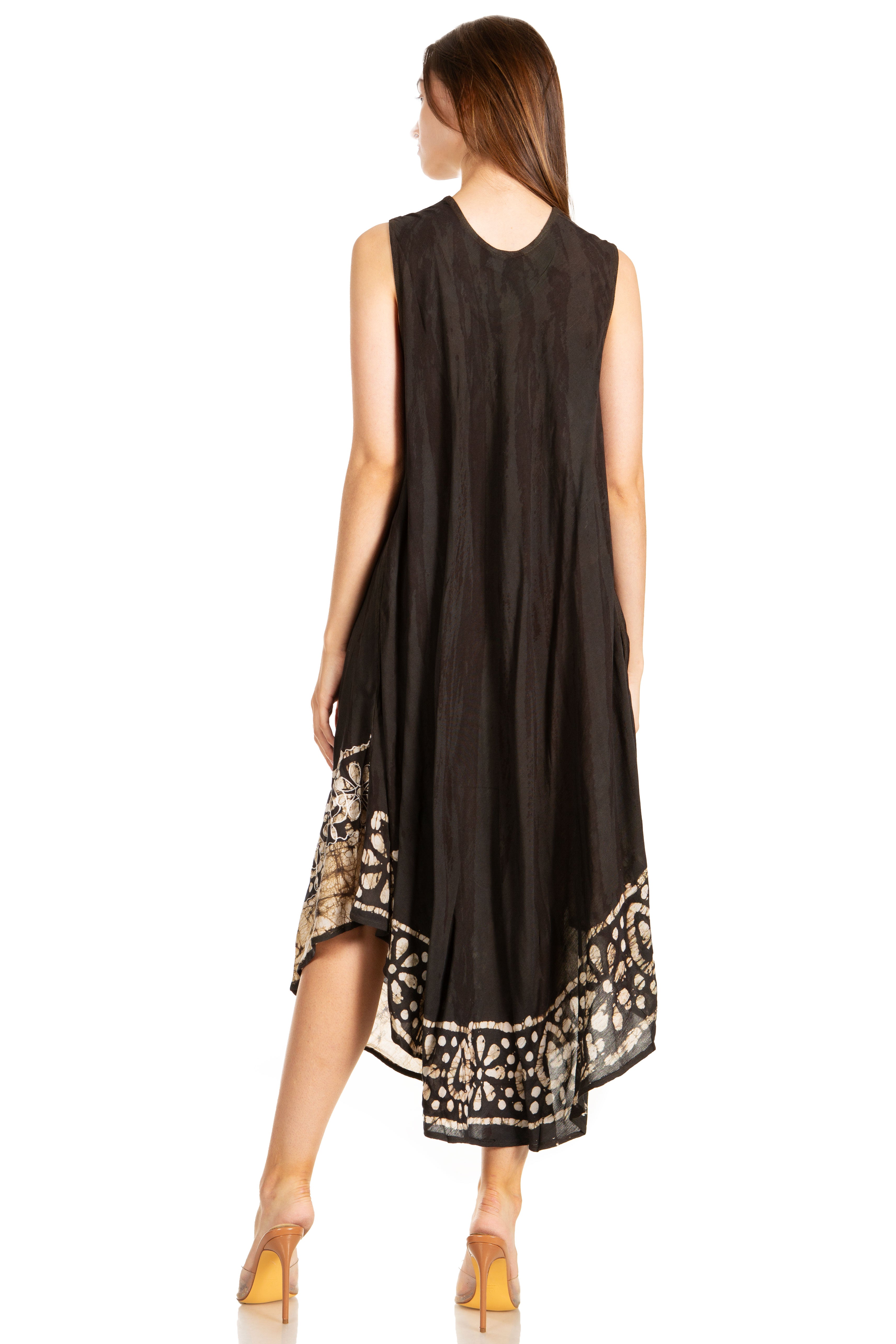Woman wearing a black sleeveless dress with patterned hem on a white background