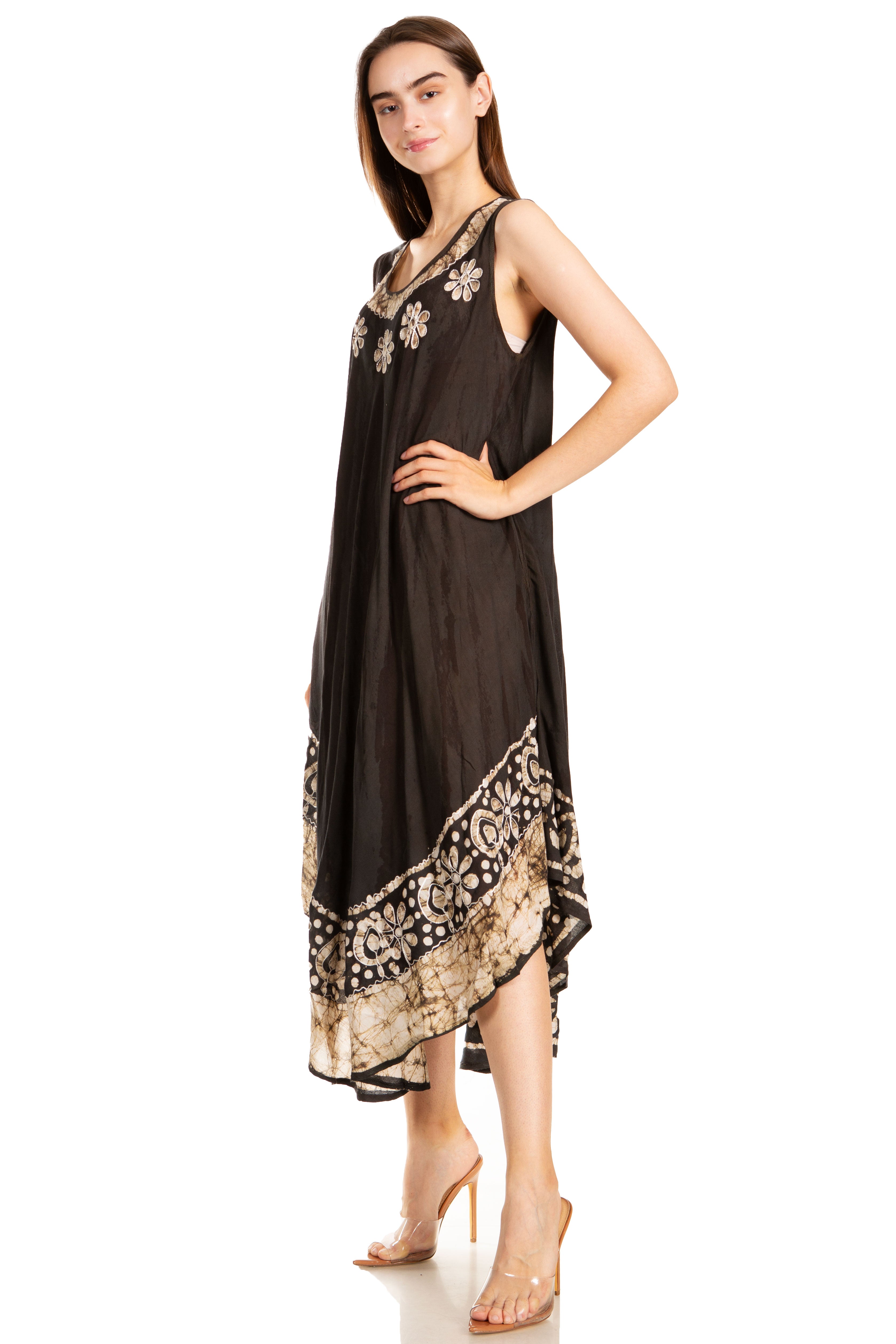 Woman wearing a black dress with gold embroidery on a white background