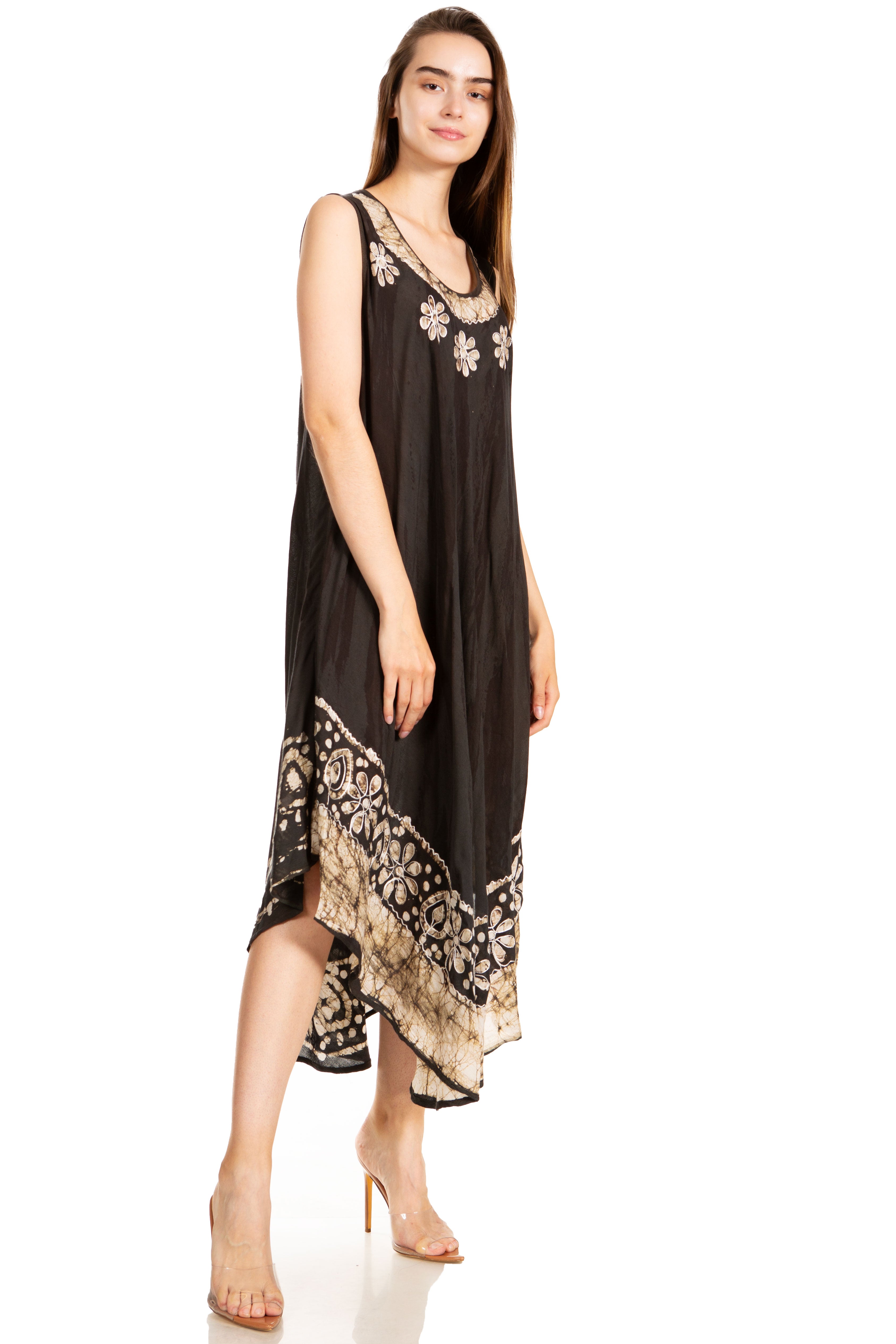 Woman wearing a black sleeveless dress with floral patterns on a white background