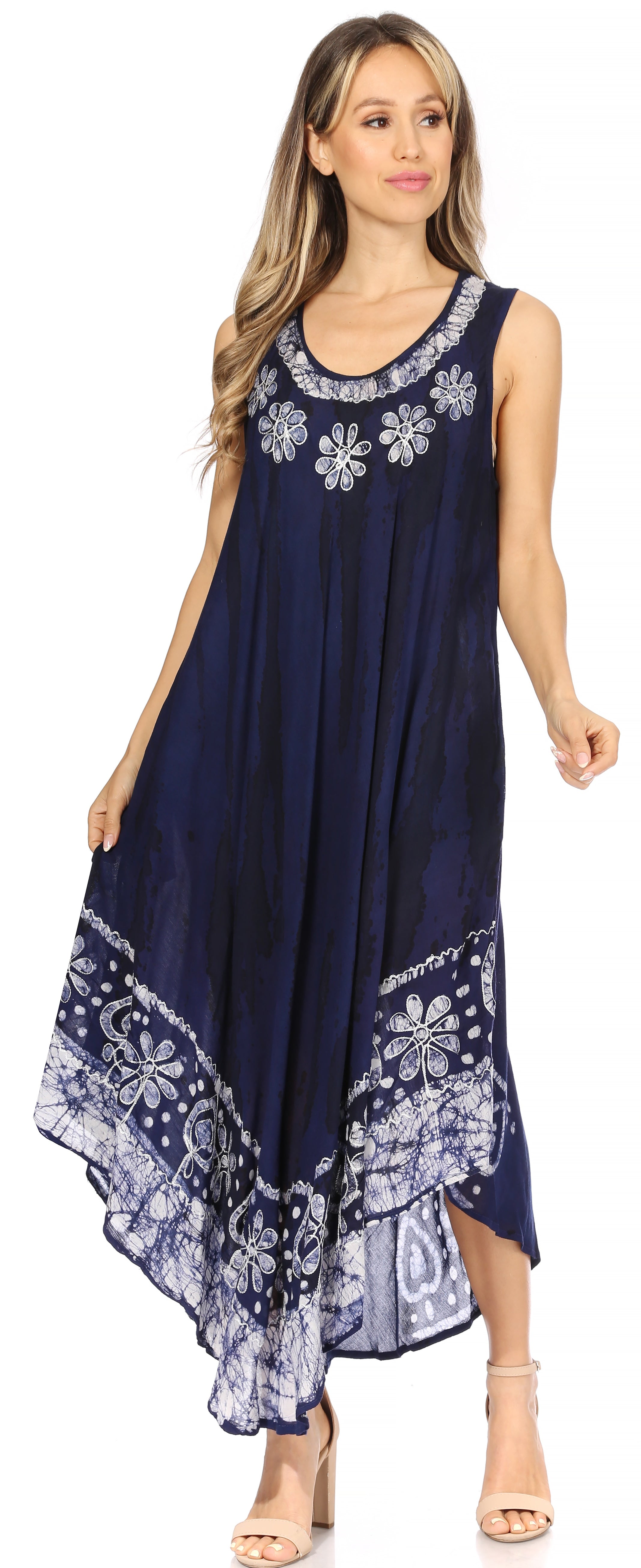 Woman wearing a navy blue dress with floral patterns on a white background
