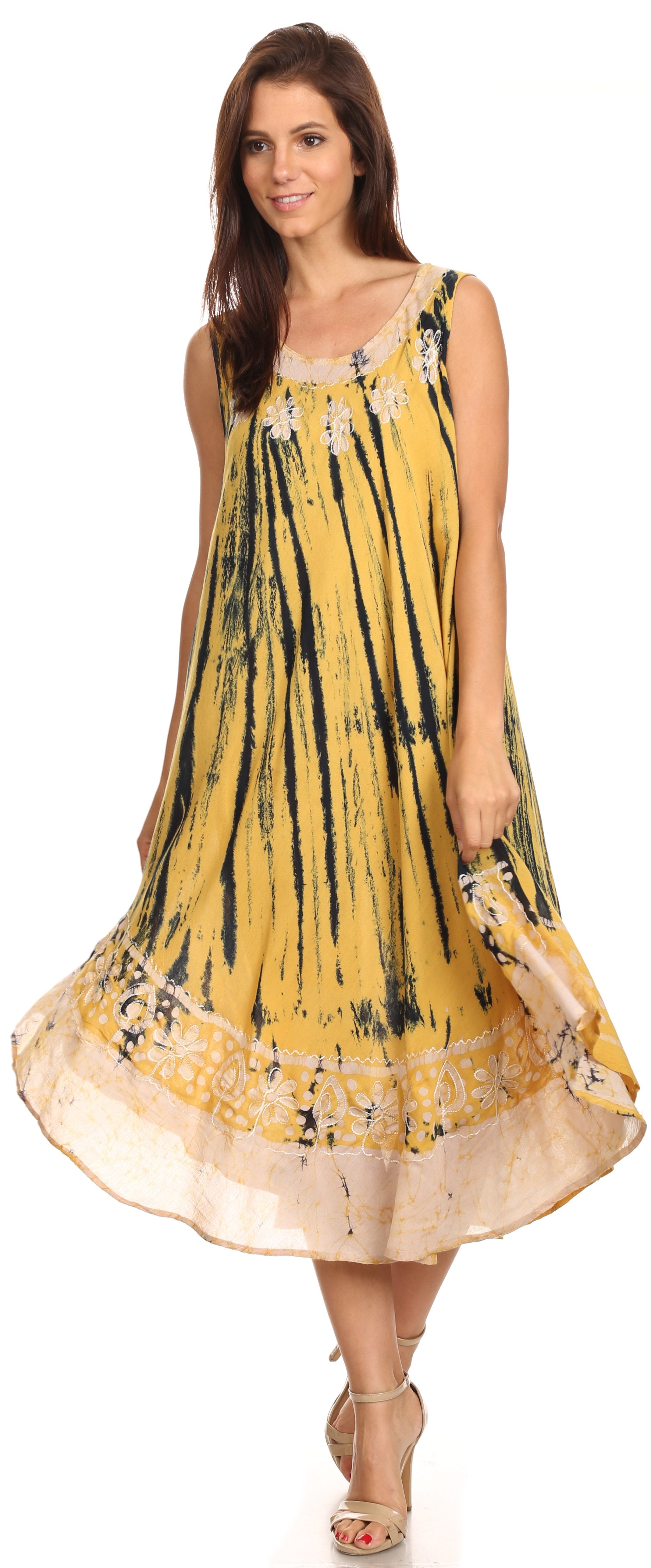 Woman wearing a yellow and black tie-dye dress on a white background