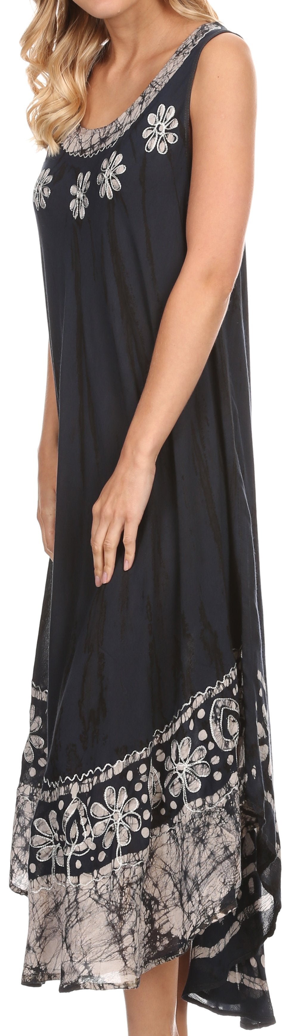 Black sleeveless dress with white floral and lace details on a plain background