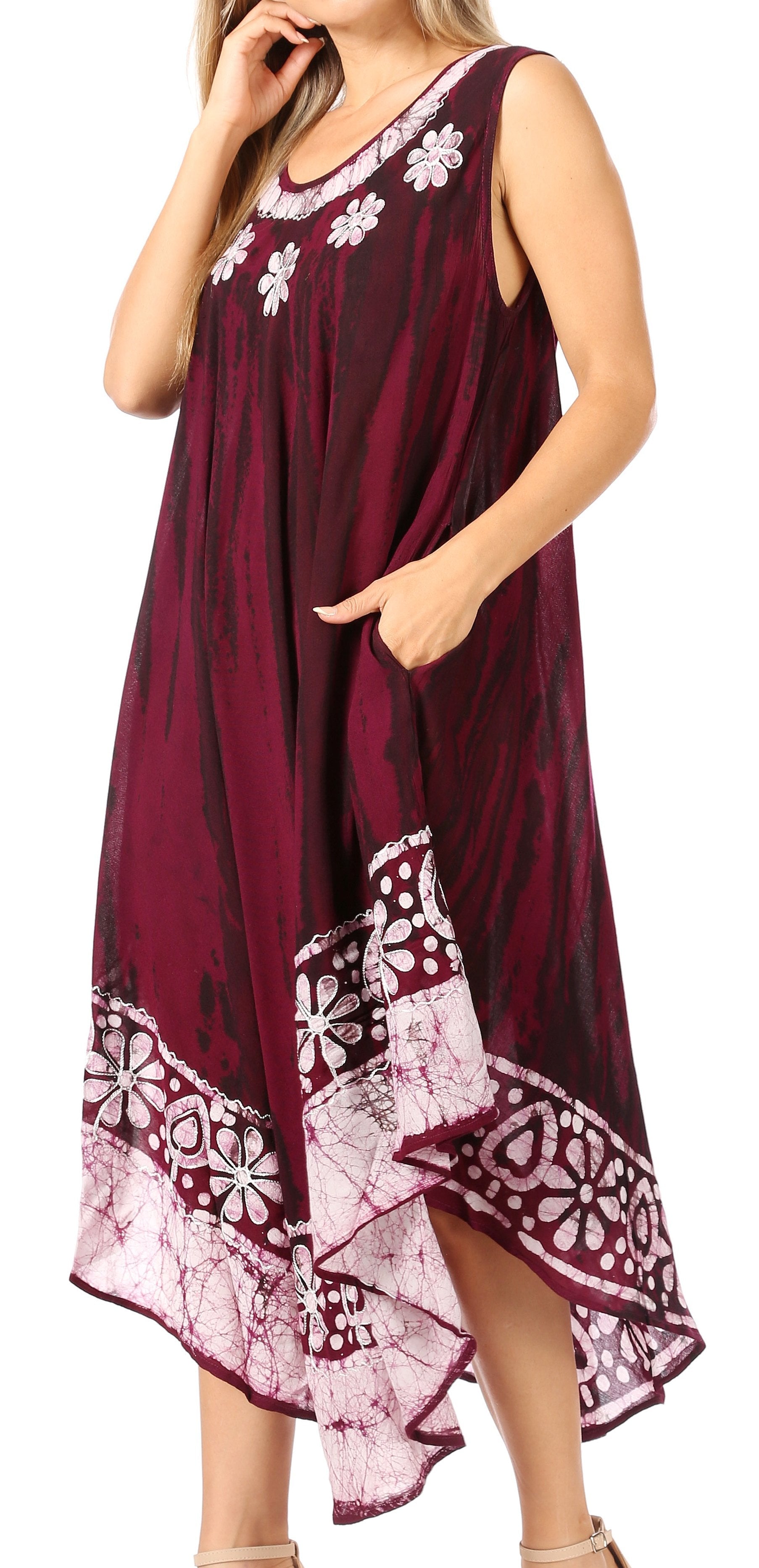 Woman wearing a burgundy dress with white floral patterns on a white background