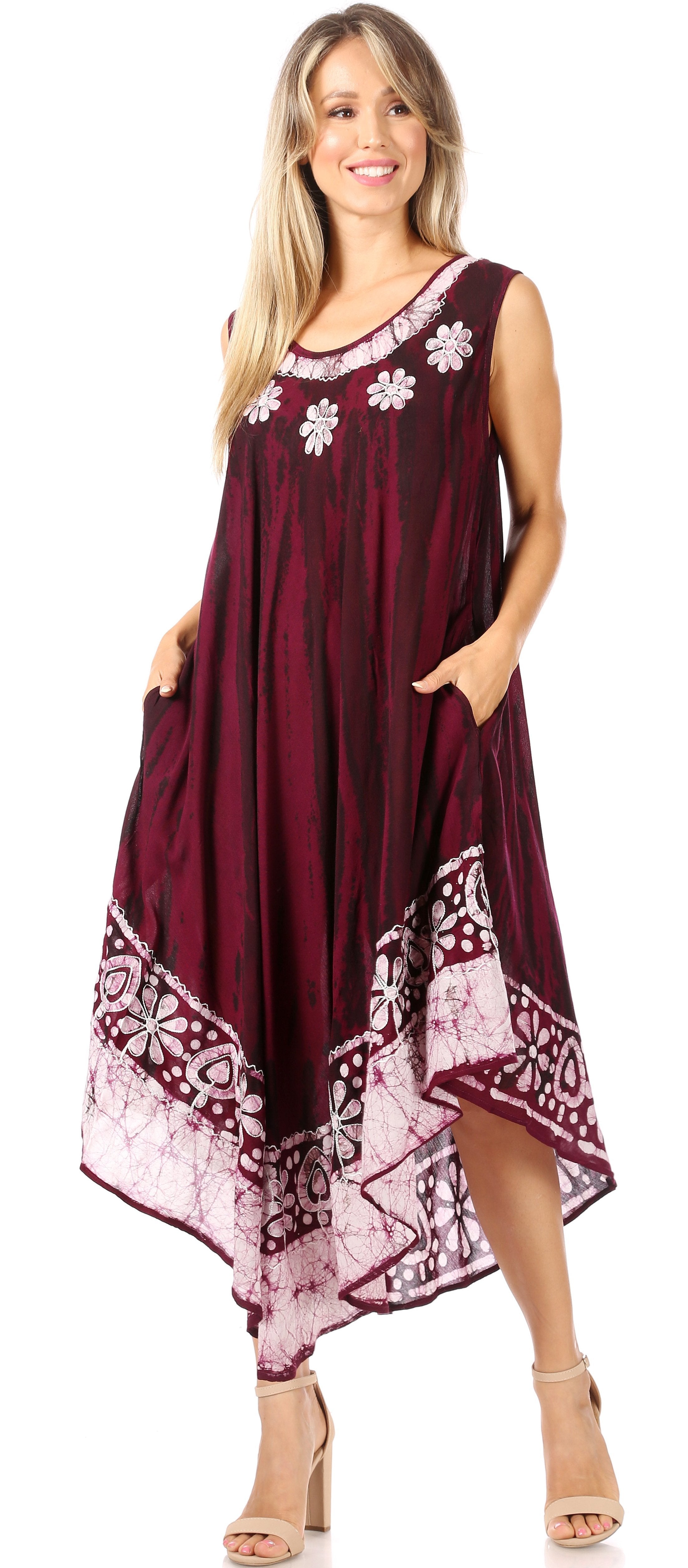 Woman wearing a burgundy dress with floral and geometric patterns on a white background