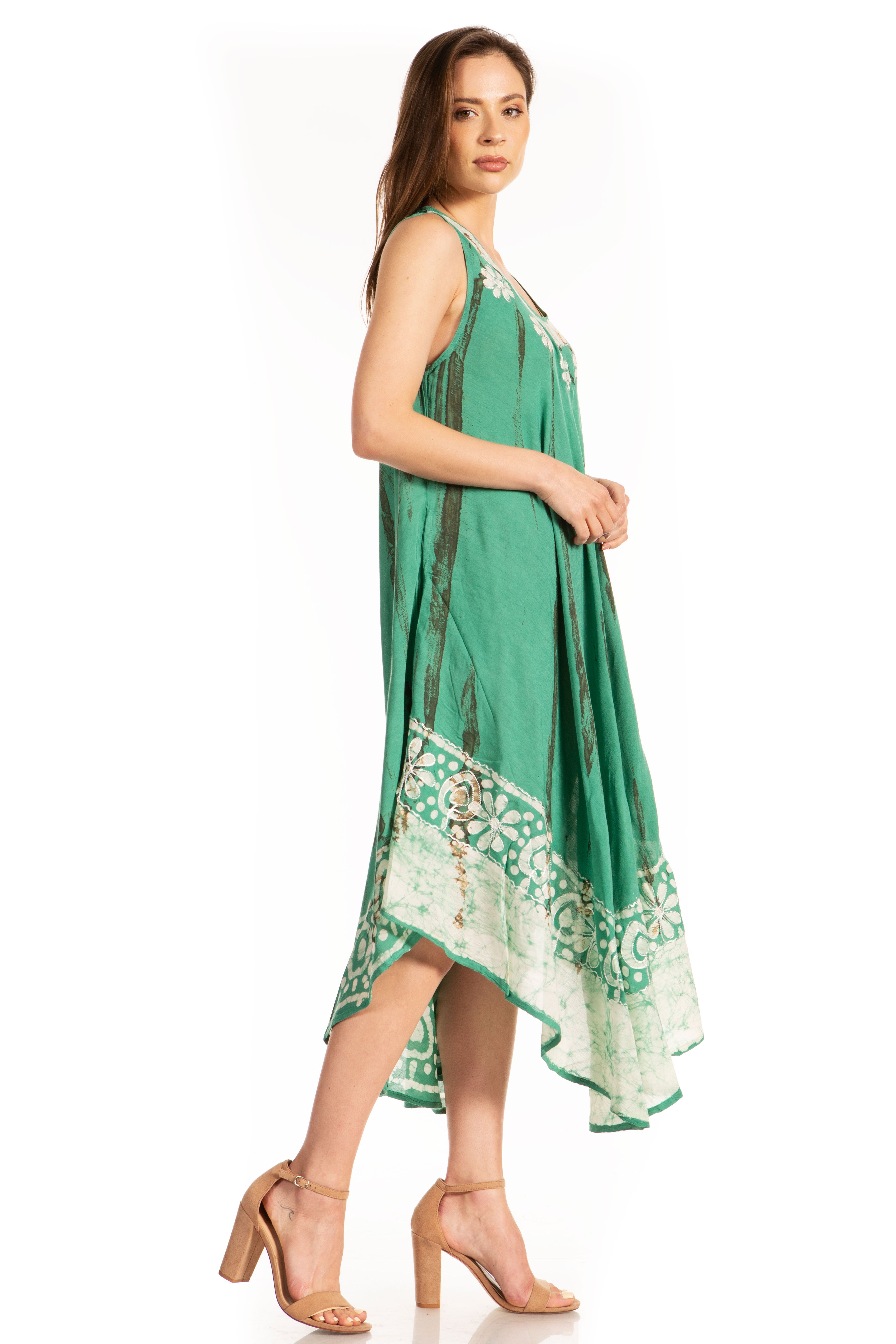 Woman wearing a green dress with white patterns on a white background