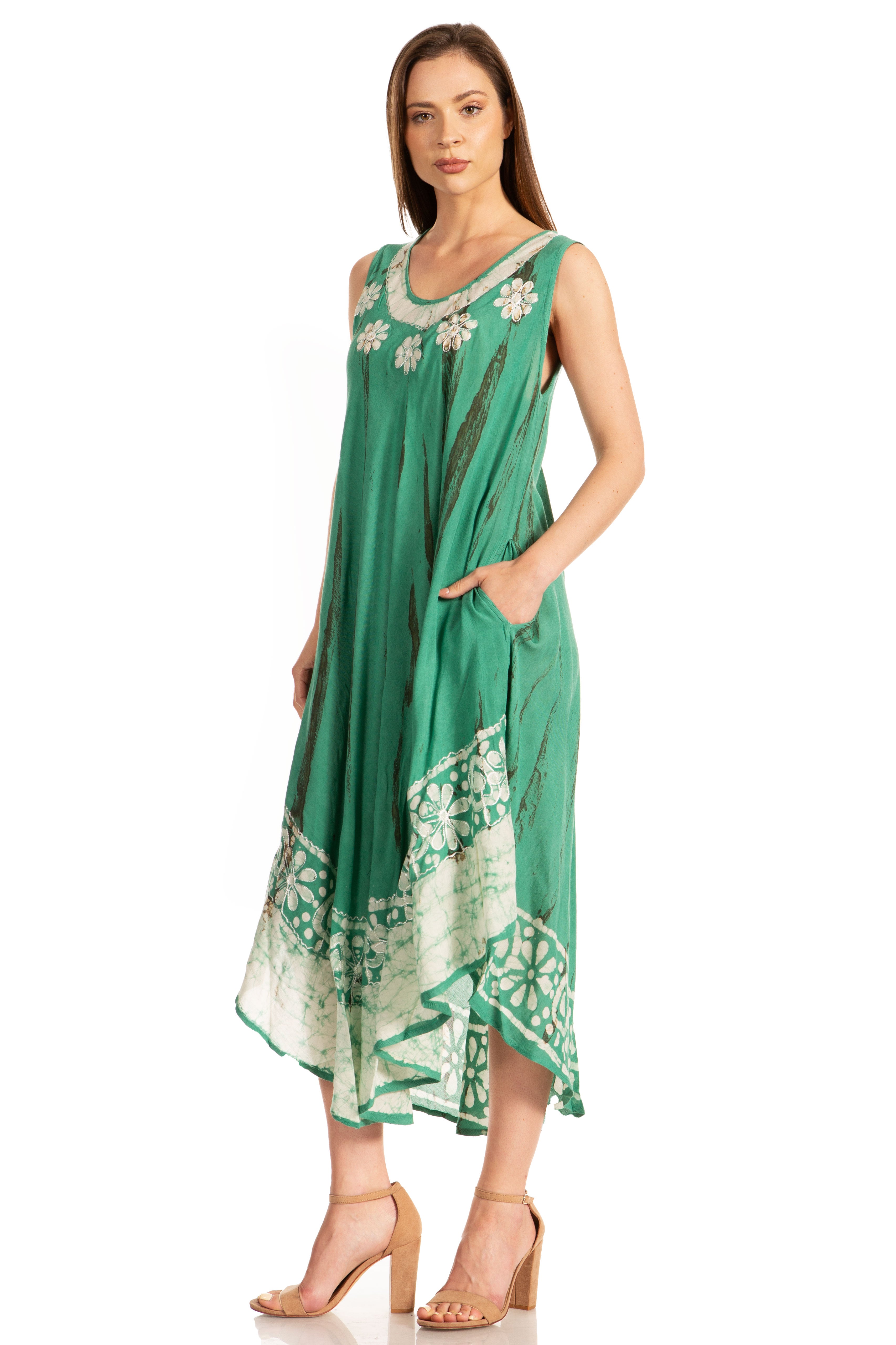 Woman wearing a green dress with floral patterns on a white background