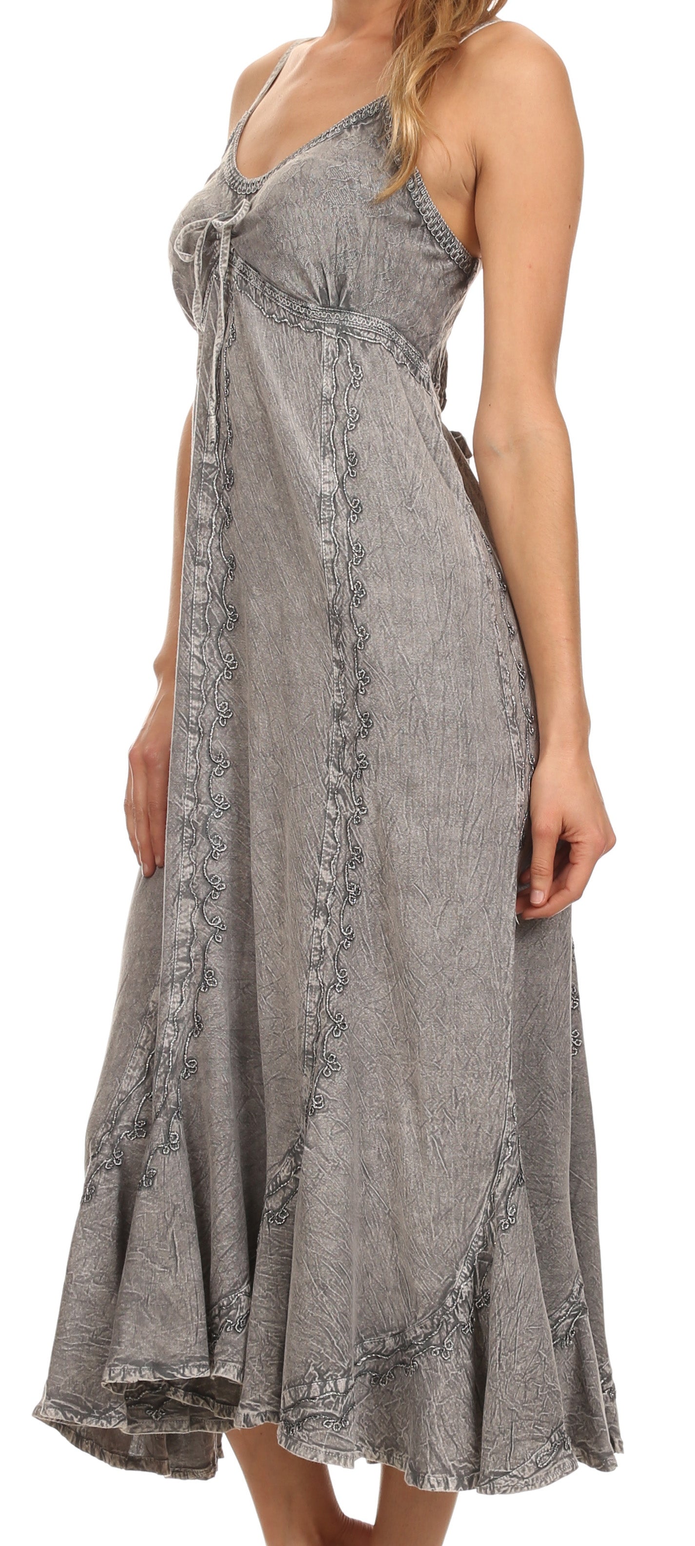 Woman wearing a gray patterned dress against a white background