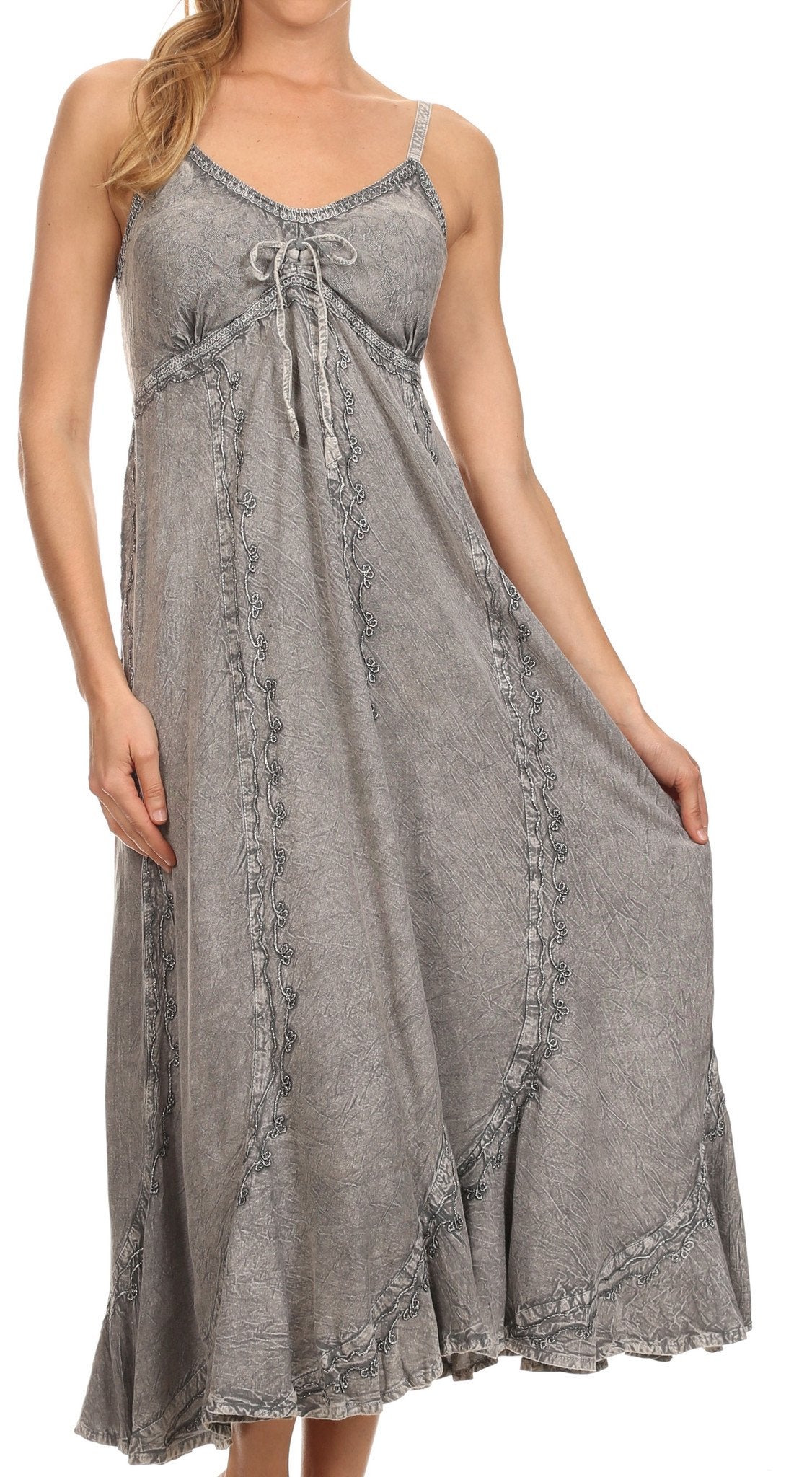 Woman wearing a gray sleeveless dress with lace details on a white background