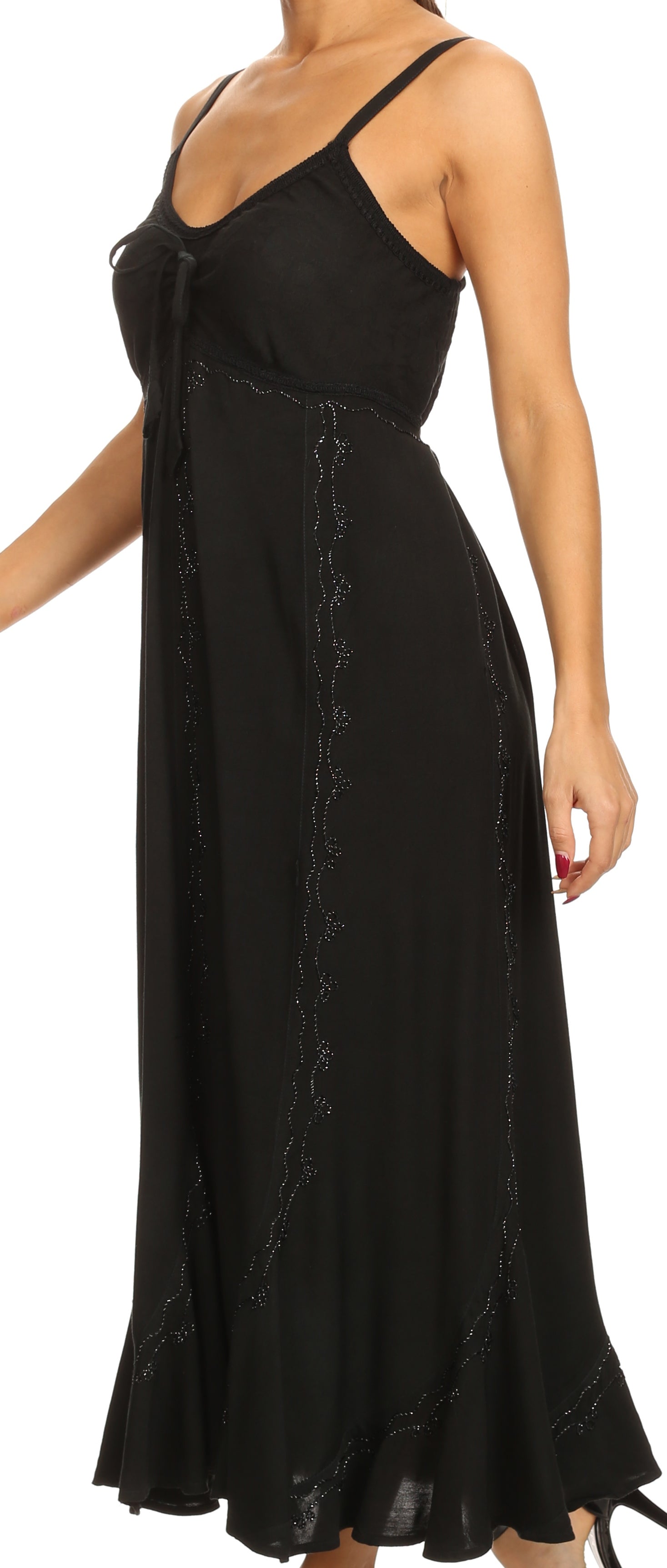 Black dress with thin straps and lace details on a white background