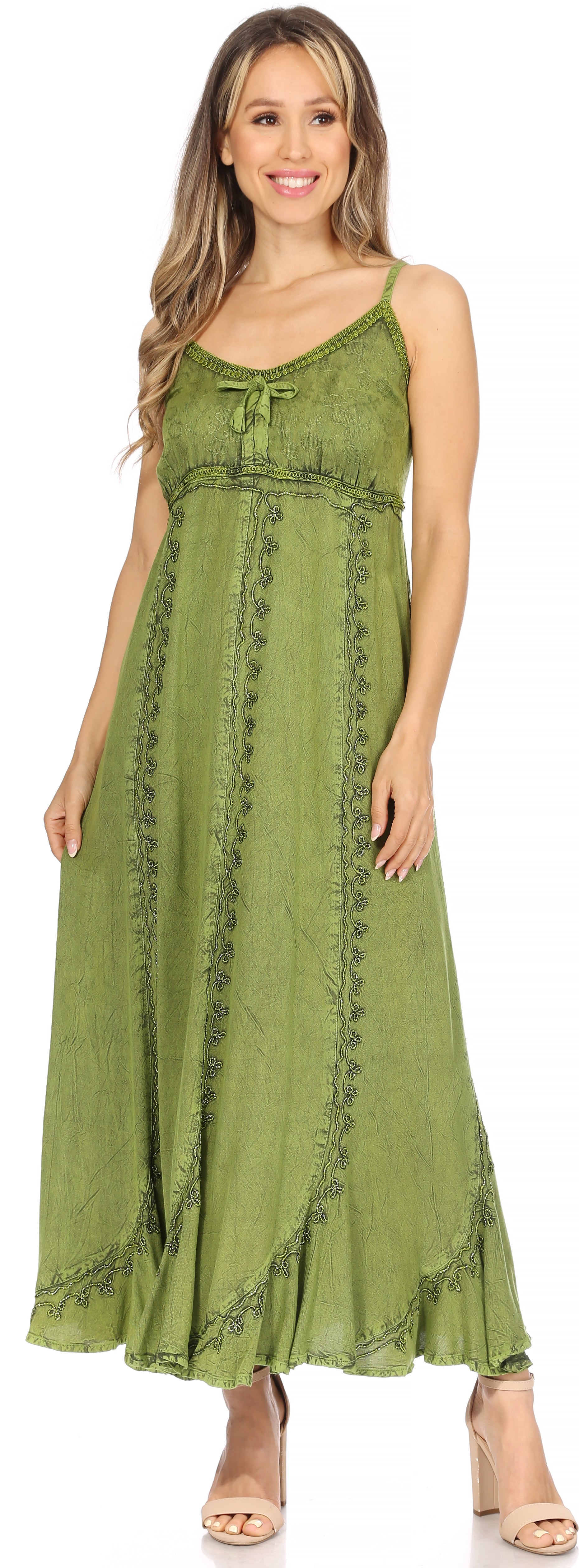 Woman wearing a green maxi dress with lace details on a white background