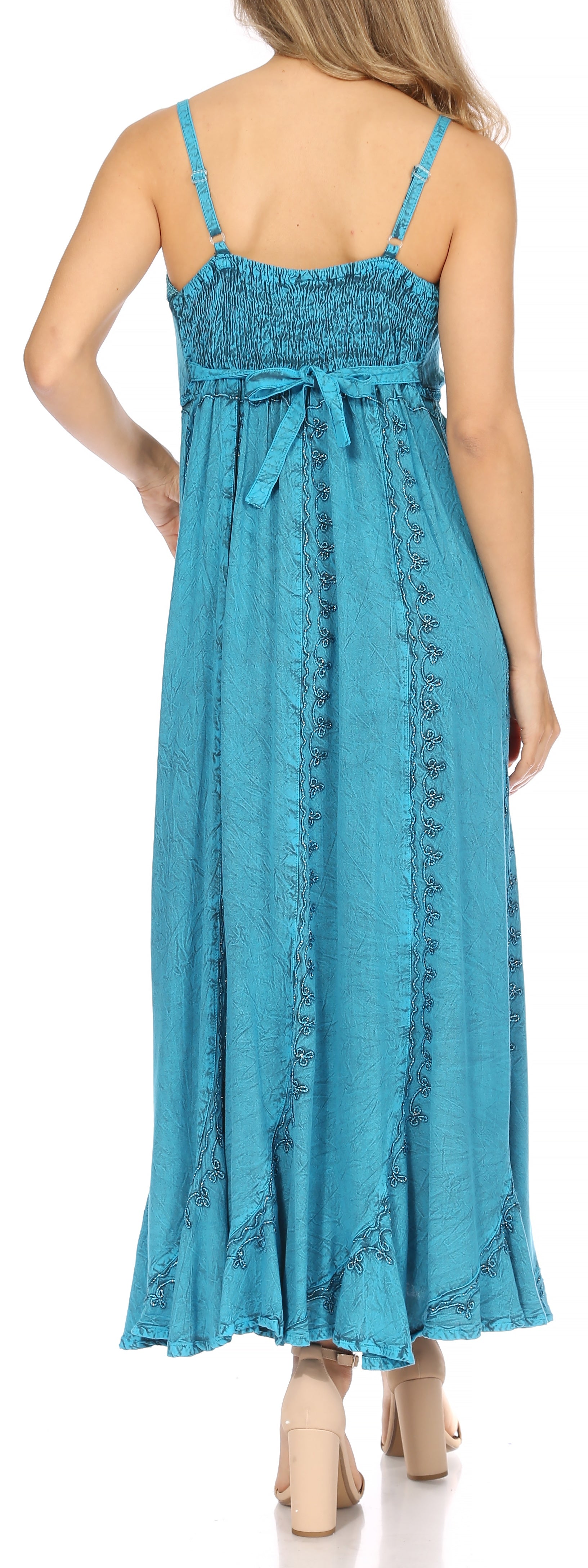 Woman wearing a blue dress with lace details on a white background