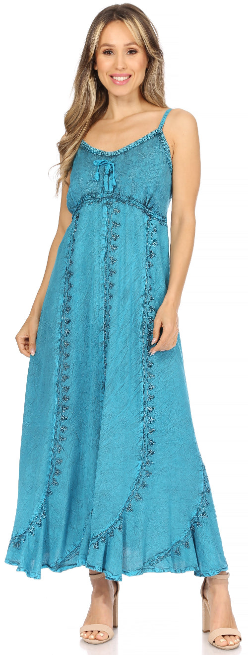 Woman wearing a blue dress with embroidery details on a white background