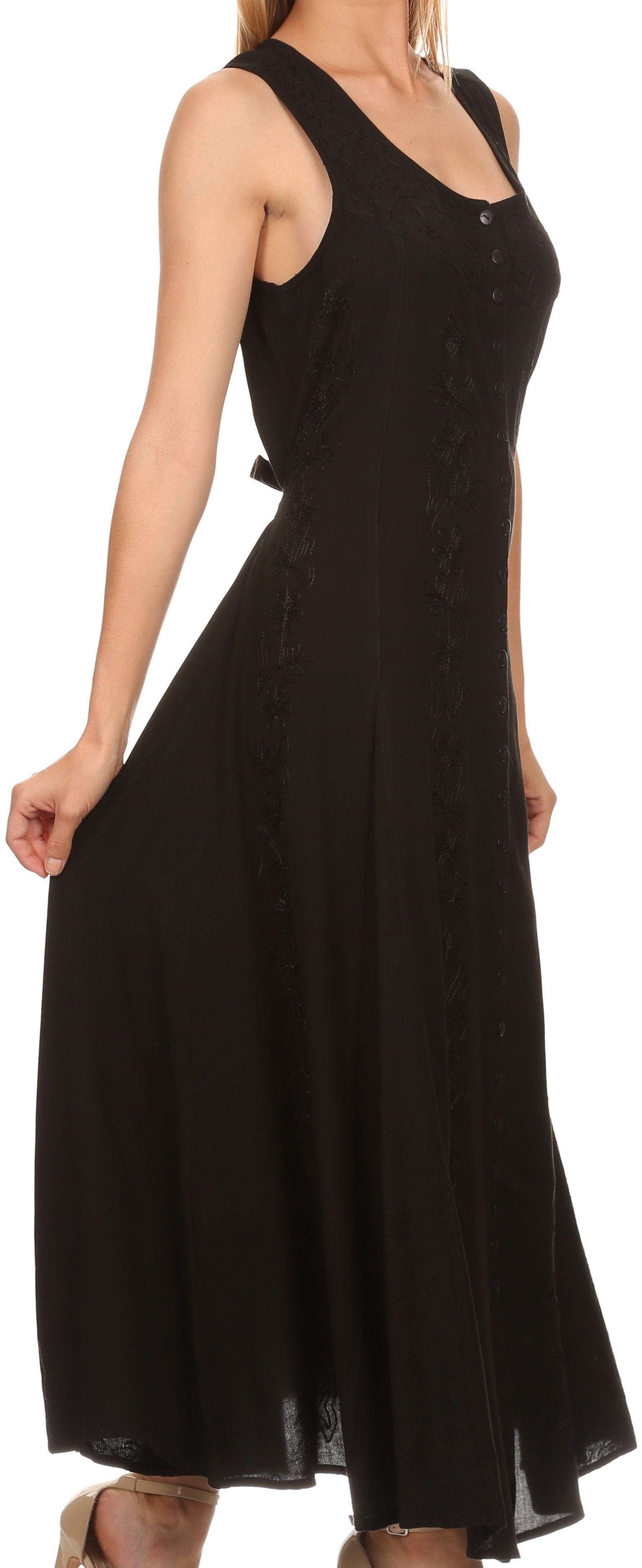 Black sleeveless dress worn by a person on a white background