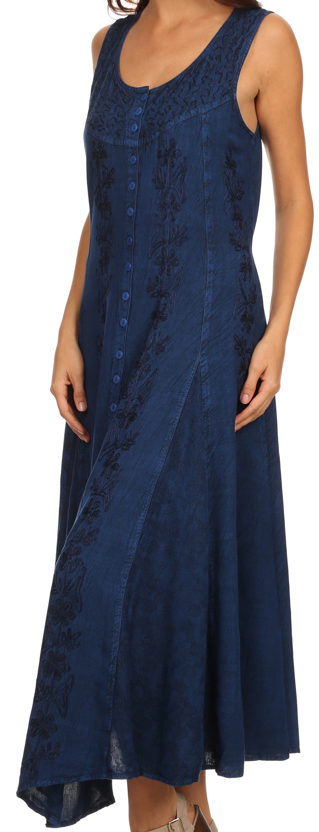 Woman wearing a sleeveless blue dress with lace details on a white background