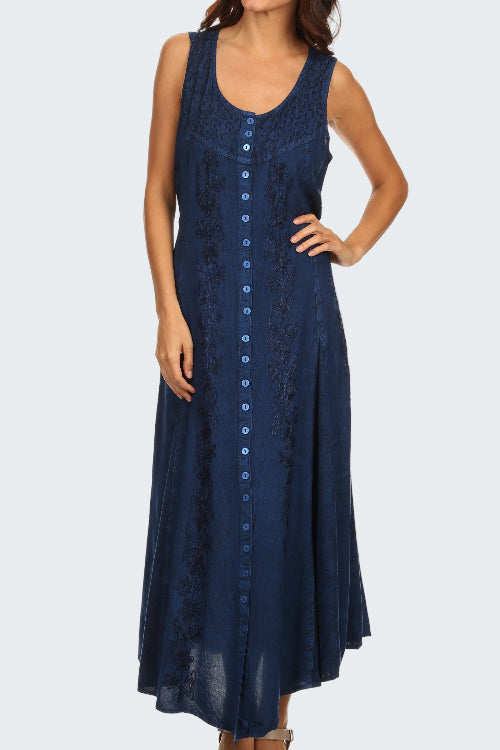 Woman wearing a navy blue sleeveless dress with buttons on a white background