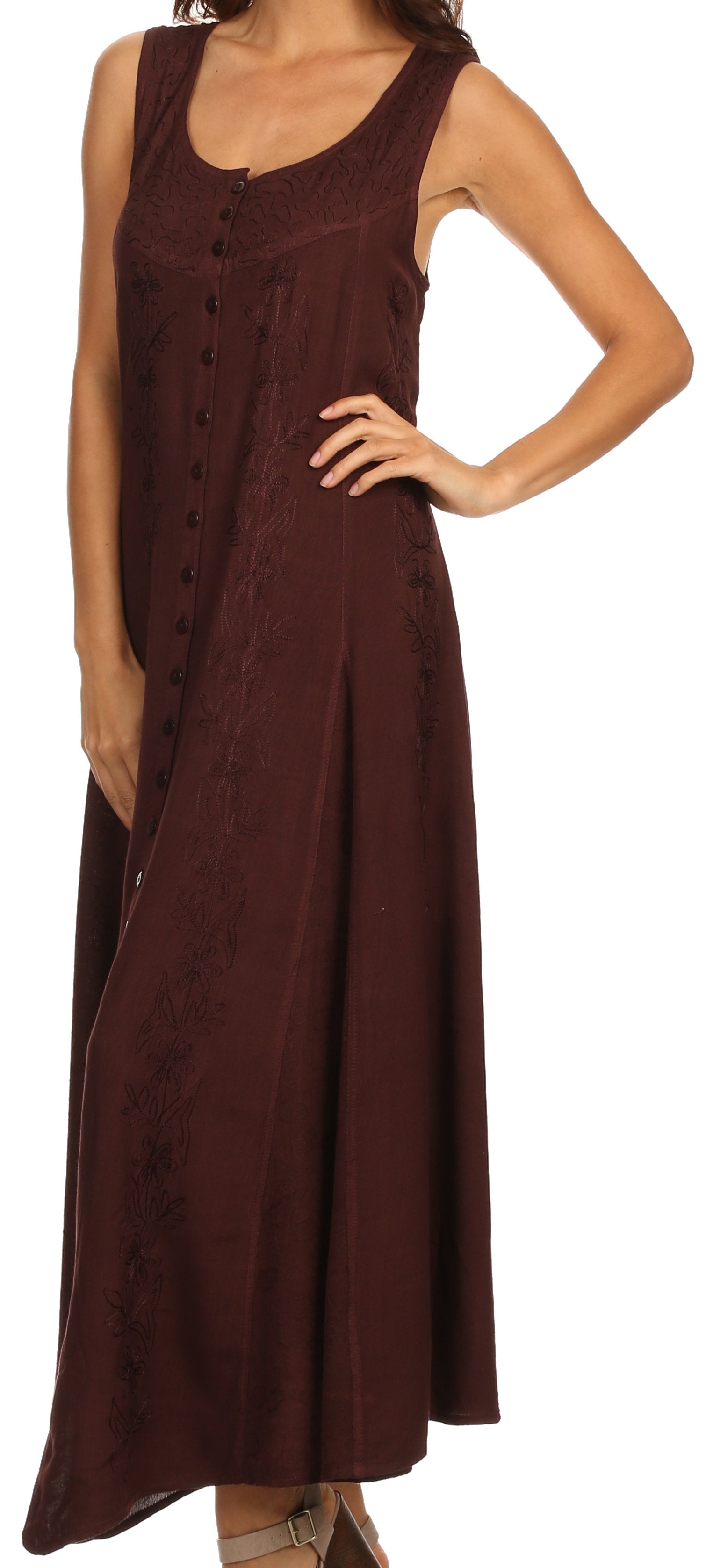 Woman wearing a brown sleeveless dress with buttons on a white background