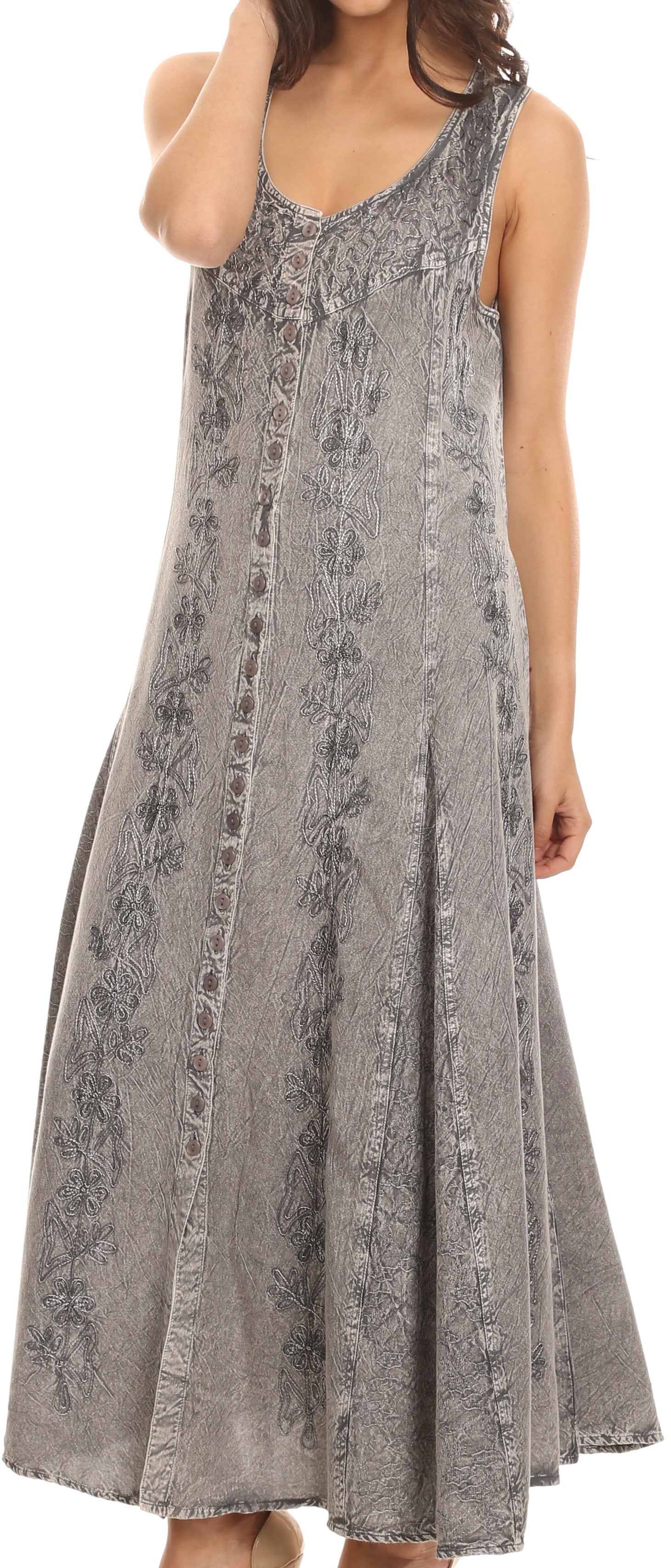 Woman wearing a sleeveless, patterned dress against a neutral background